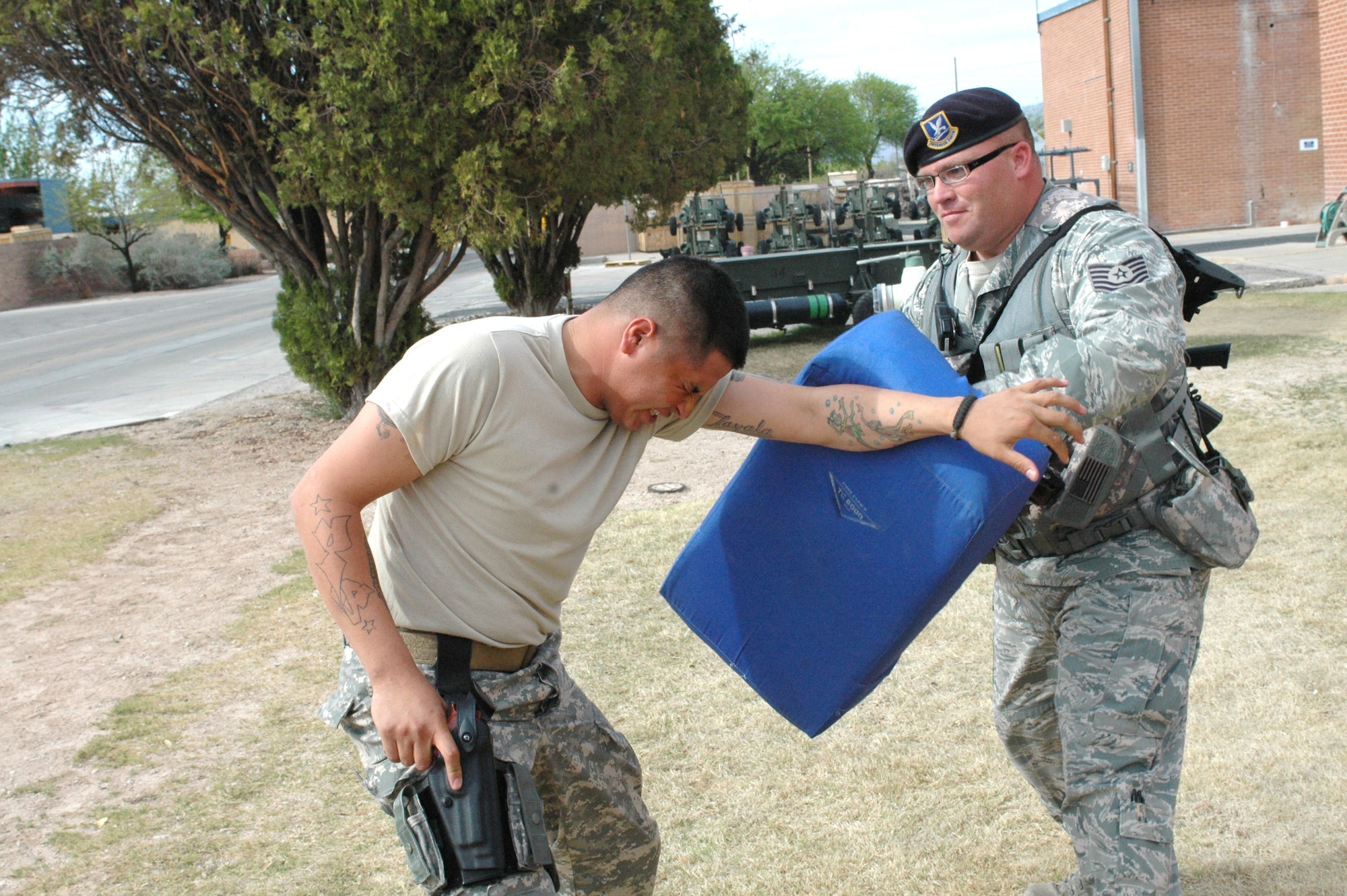 Army Specialist Jose Zavala, left, fights off Tech. Sgt. Michael Royval after being sprayed in the face with pepper spray at the 162nd Fighter Wing in Tucson, Ariz., April 7. All Security Forces members who have not experienced the non-lethal agent are now required to learn its effects according to a new Air Force manual on the use of force. (Air National Guard photo by Capt. Gabe Johnson)