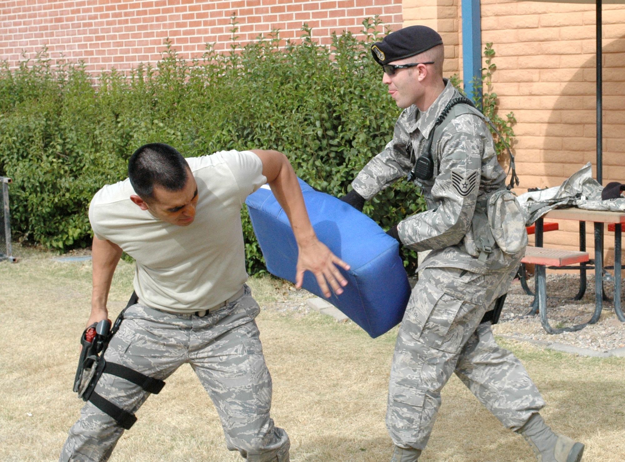 Senior Airman Joe De Vos, left, fights off Tech. Sgt. Jonathan Wallace after being sprayed in the face with pepper spray at the 162nd Fighter Wing in Tucson, Ariz., April 7. All Security Forces members who have not experienced the non-lethal agent are now required to learn its effects according to a new Air Force manual on the use of force. (Air National Guard photo by Capt. Gabe Johnson)