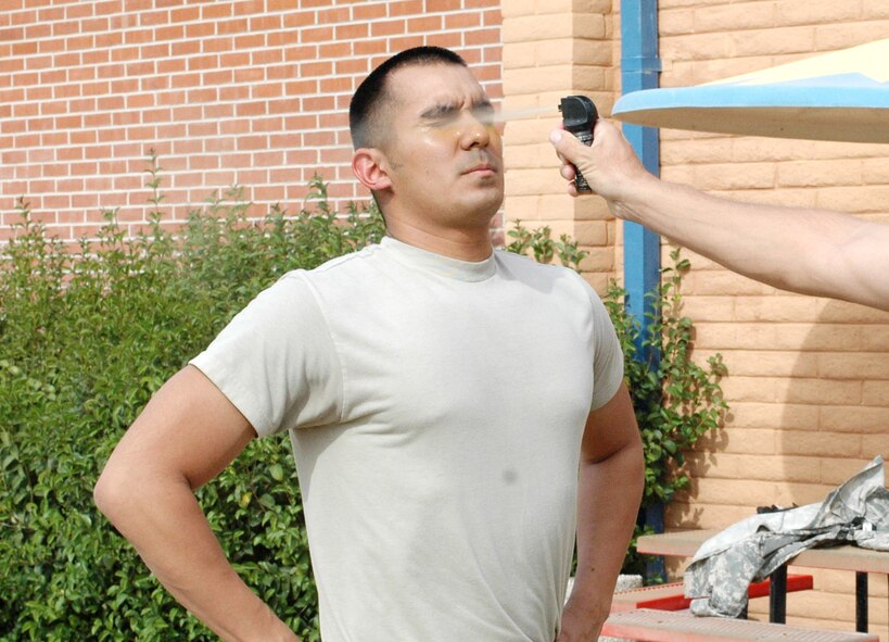 Senior Airman Joe De Vos gets sprayed in the face with pepper spray at the 162nd Fighter Wing in Tucson, Ariz., April 7. All Security Forces members who have not experienced the non-lethal agent are now required to learn its effects according to a new Air Force manual on the use of force. (Air National Guard photo by Capt. Gabe Johnson)