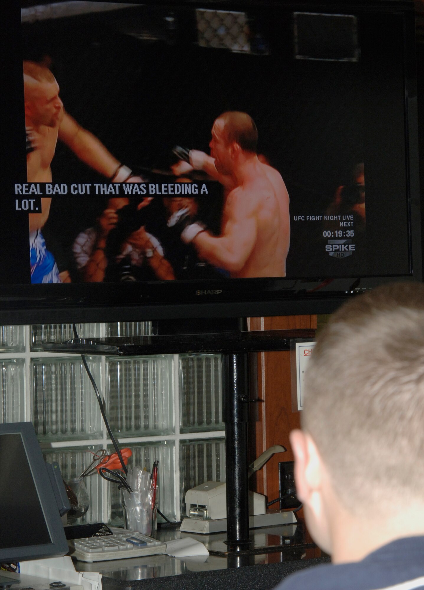 MCCONNELL AIR FORCE BASE, Kan. -- Senior Airman Daniel Mills, 22nd Air Refueling Wing command chief’s assistant, watches an Ultimate Fighting Championship at the Storm Cellar, April 1. The event headlined fighting champions Carlos Condit vs. Martin Kampmann in addition to various other fighters. (Photo by Senior Airman Laura Suttles)