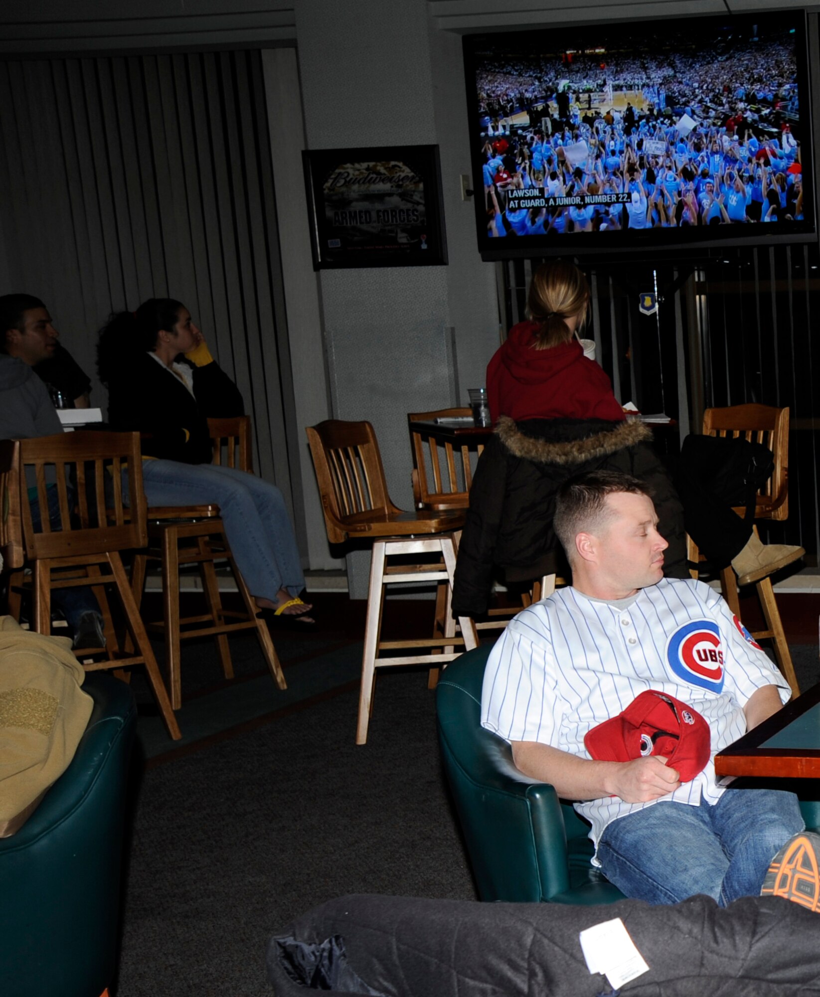MCCONNELL AIR FORCE BASE, Kan. -- Airmen relax and socialize while watching the National Collegiate Athletic Association Championship game featuring Michigan vs. the University of North Carolina at the Storm Cellar, April 6. The Storm Cellar provided free chicken wings while the Airmen watched the game on six televisions and a projection screen, all with surround sound. (Photo by Airman Justin Shelton) 
