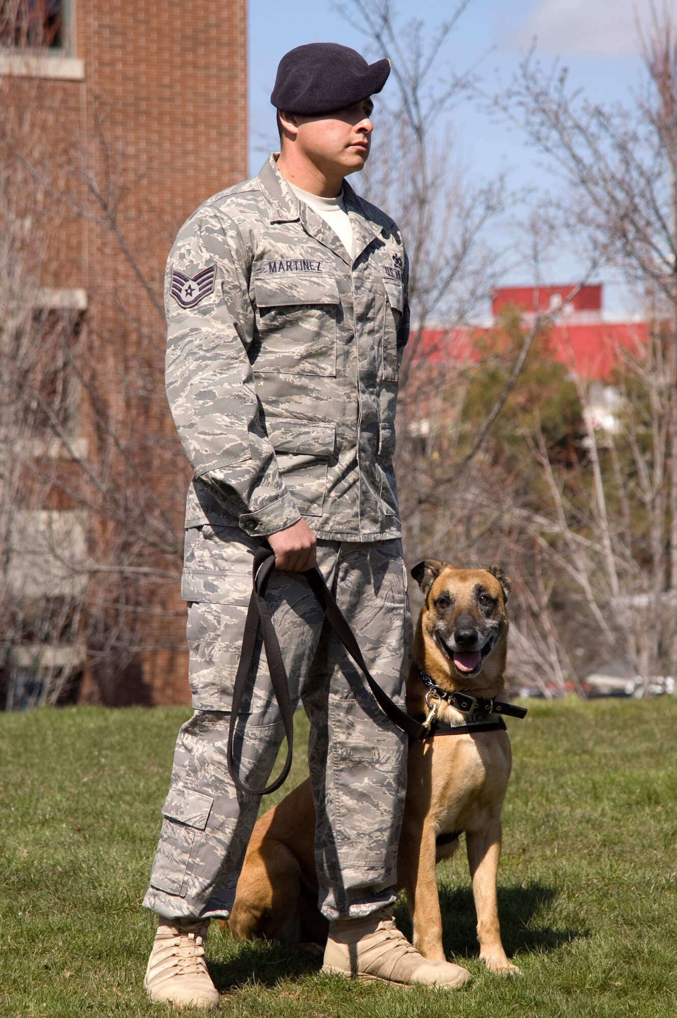 MWD Lucky stands next to handler Staff Sgt. Gerald Martinez, 92nd Security Forces Squadron. (Courtesy photo)