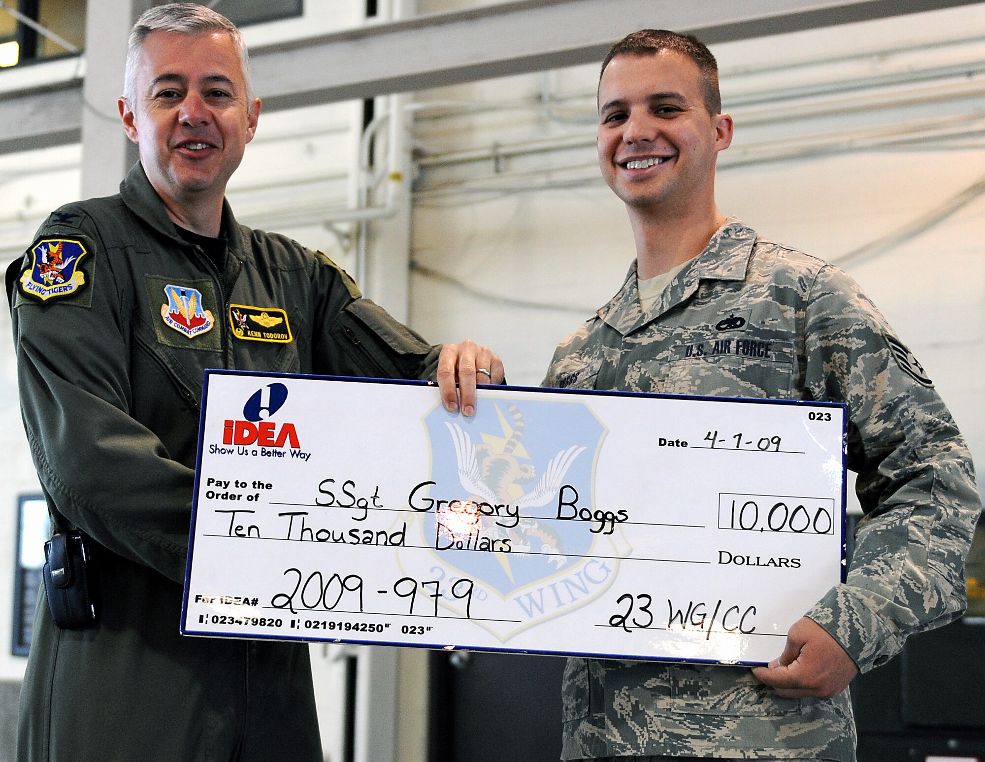 MOODY AIR FORCE BASE, Ga. -- Col. Kenneth Todorov, 23rd Wing commander, presents a check for $10,000 to Staff Sgt. Gregory Boggs, 41st Helicopter Maintenance Unit weapons maintenance chief, here April 7. Sergeant Boggs was awarded the check through the Air Force's IDEA program. He submitted an IDEA to repair 50 booster motors with an inexpensive pin rather than spending money to replace them. (U.S. Air Force photo by Airman Joshua Green) 

