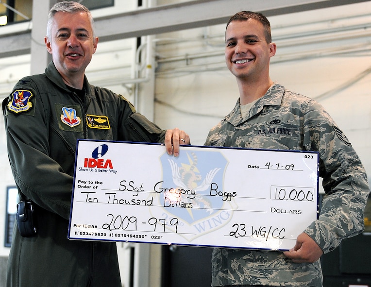 MOODY AIR FORCE BASE, Ga. -- Col. Kenneth Todorov, 23rd Wing commander, presents a check for $10,000 to Staff Sgt. Gregory Boggs, 41st Helicopter Maintenance Unit weapons maintenance chief, here April 7. Sergeant Boggs was awarded the check through the Air Force's IDEA program. He submitted an IDEA to repair 50 booster motors with an inexpensive pin rather than spending money to replace them. (U.S. Air Force photo by Airman Joshua Green) 

