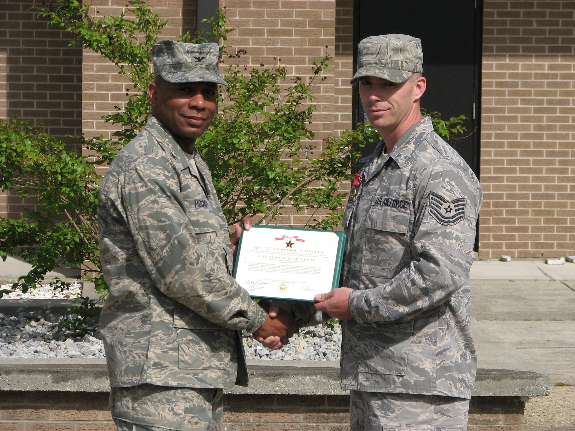 Col. Tony Pounds, 782nd TRG commander, presents Tech. Sgt. Timothy Bayes, an instructor at the 782nd Training Group Detachment 6 in, Gulfport, Miss. with the Bronze Star award Mar. 30. (U.S. photo/ Petty Officer Second Class Corey Self)