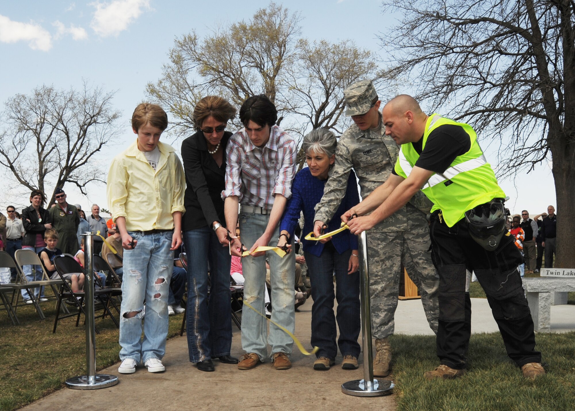 MCCONNELL AIR FORCE BASE, Kan. -- Lisa Krueger, wife of Col. Michael Krueger, 22nd Air Refueling Wing former vice commander, and her two sons, Drake and reed along with Ida Simpkins, 22nd Force Support Squadron deputy commander, Airman 1st Class Dakota Tyree, 22nd Civil Engineer Squadron, and Tech. Sgt. Brian Denis, 22nd Aircraft Maintenance Squadron, cut the ribbon to the opening of the new Krueger Recreation Area, April 4. The Krueger Recreation Area includes an All Terrain Vehicles track, miniature remote control track, disc golf area, paintball zone, camping grounds and fishing ponds, available to military members and their families’ enjoyment. (Photo by Airman 1st Class Maria Ruiz)