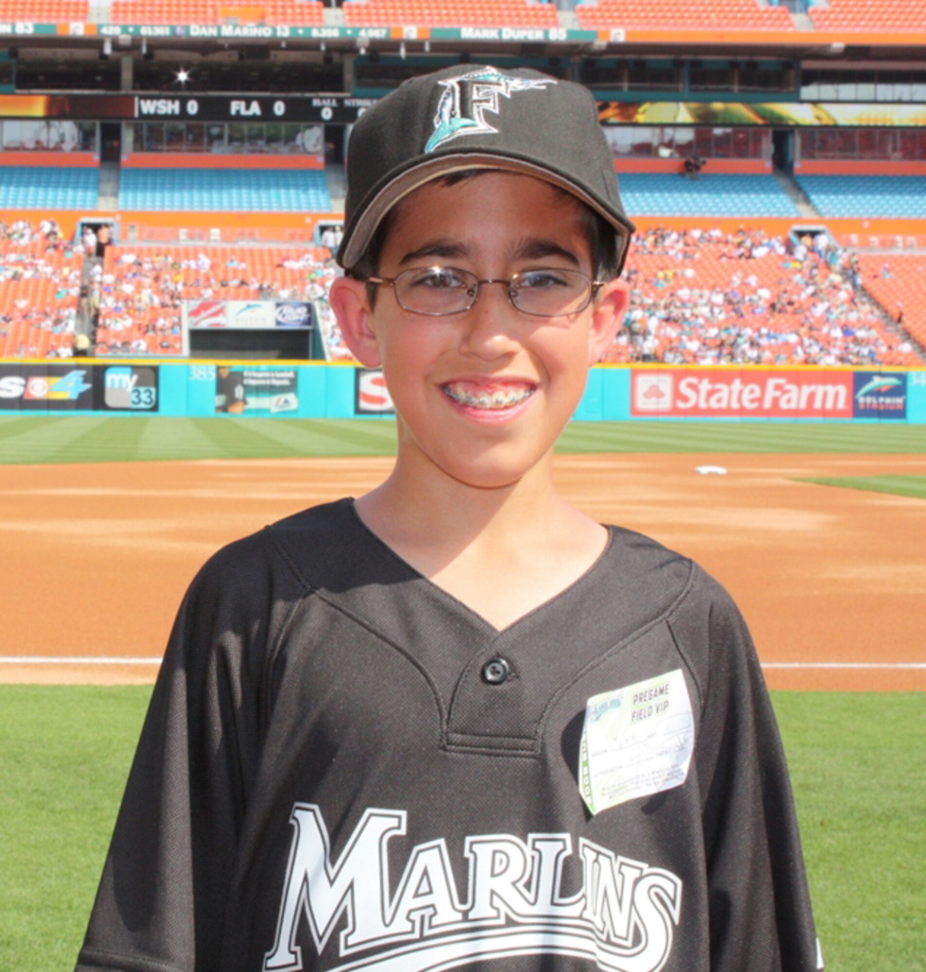 Sean Romero waits to throw the first pitch of the Florida Marlins 2009 Major League Baseball season in front of 33,000 fans April 6, 2009, at Dolphin Stadium in Miami Gardens, Fla. Sean is the son of Senior Master Sgt. Tony Romero, NCO in charge of life support for Air Force Reserve Command's 93rd Fighter Squadron at Homestead Air Reserve Base, Fla. Sergeant Romero is deployed to Joint Base Balad, Iraq., where he was filmed giving a "shout out" to Marlins' fans and asking his son to help him with the opening pitch for the Marlins' pre-game tribute to the military. The Marlins' director of game presentation proposed the idea of having the son or daughter of a deployed reservist throw out the first pitch after Homestead's 482nd Fighter Wing coordinated the opening day F-16 flyover with the Marlins' organization. (U.S. Air Force photo/2nd Lt. Erik Hofmeyer)

