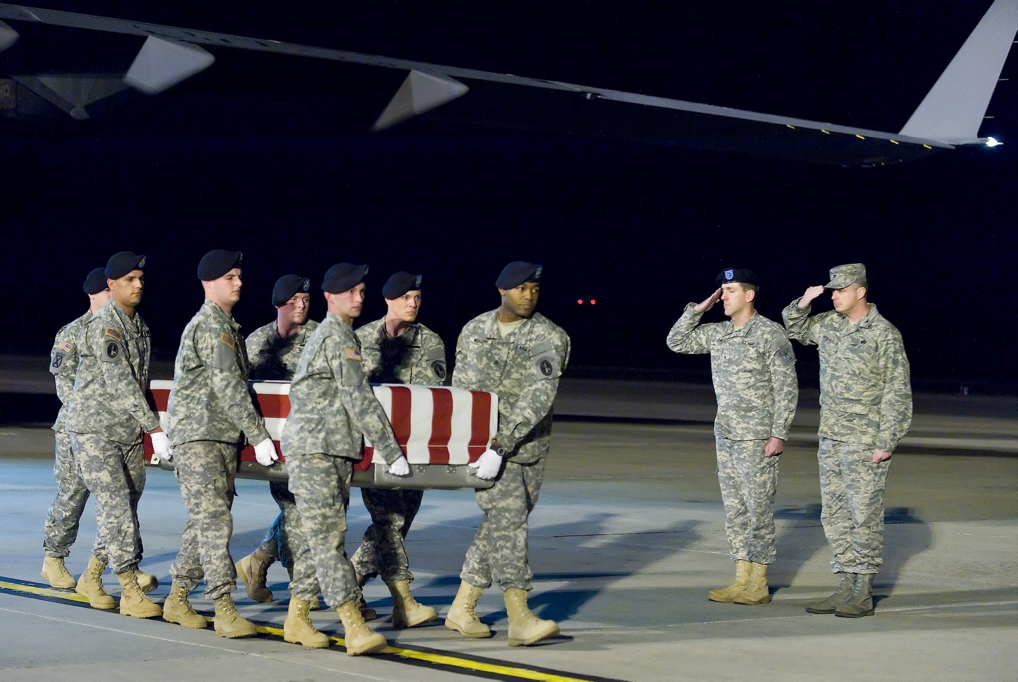 An Army carry team transfers the remains of Army Spc. Israel Candelaria Mejias, of San Lorenzo, Puerto Rico, at Dover Air Force Base, Del., April 7. Specialist Candelaria Mejias died April 5 near Baghdad, Iraq, of wounds sustained when a mine detonated near him during combat operations. He was assigned to the 1st Battalion, 2nd Infantry Regiment in Task Force 3rd Battalion, 66th Armor Regiment, 172nd Brigade Combat Team, Grafenwoehr, Germany. (U.S. Air Force photo/Roland Balik)