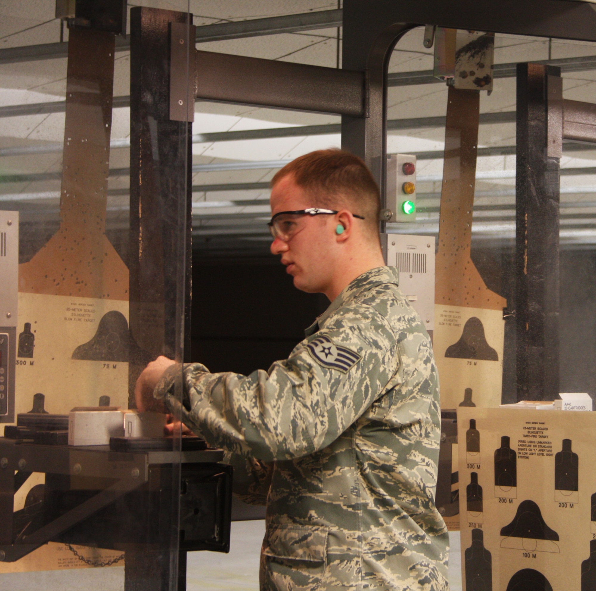 WRIGHT-PATTERSON AFB, Ohio – Staff Sgt. Matthew Hallam, 87th Aerial Port Squadron, watches a fellow reservist shoot as he loads his weapon during combat arms training during the April 5th unit training assembly.  In preparation for any future deployment, reservists from the squadron made sure they were current in their training requirements. (Air Force photo/Amanda Duncan)