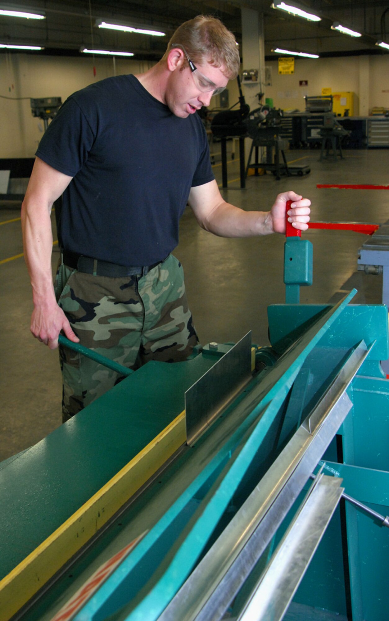 Senior Airman Chris Bates, 9th Maintenance Squadron aircraft structural maintenance journeyman, manipulates sheet metal to form the right shape needed for the U-2 Dragon Lady, April 8 in the fabrication shop. Various shapes are needed to keep the U-2 in top condition. (Photo by Airman 1st Class David Tracy)