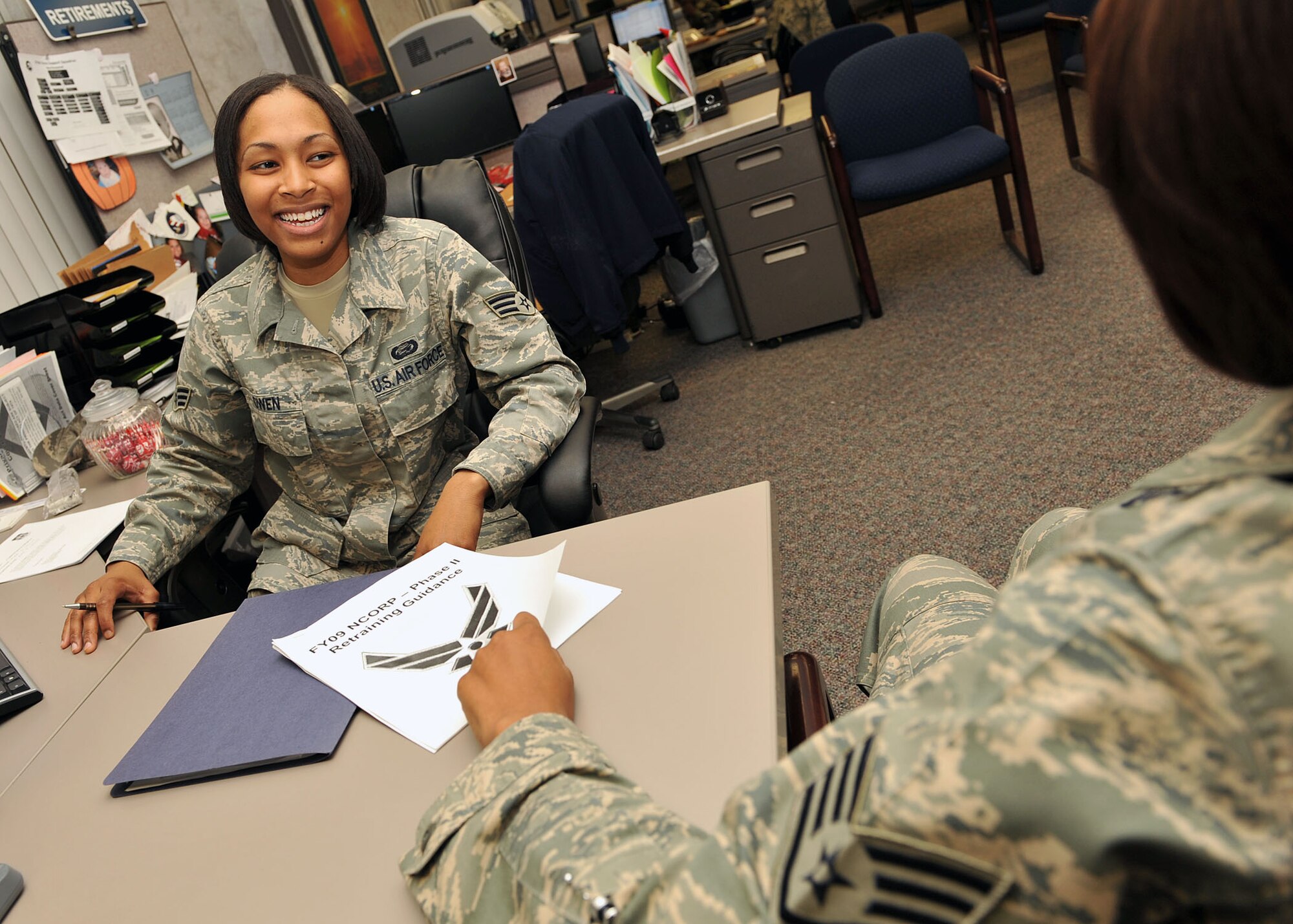 SCOTT AIR FORCE BASE, Ill. --Senior Airman Tiffany Owen, 375th Force Support Squadron, speaks to a customer regarding the Phase II non commissioned officer retraining program. The involuntary phase of the program will run now through May 31. Team Scott members should contact their local military personnel flight for complete details and a list of available retraining-in and retraining-out AFSCs.(U.S. Air Force photo/Senior Airman Megan Gilliland ) 