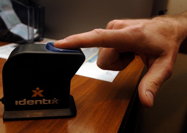 Army Sgt. Maj. Roger Dangerfield has his fingerprint scanned into the Defense Biometric Identification System at the visitor's center on Charleston AFB April 6. Several pieces of information are obtained from individuals for DBIDS including pictures and fingerprints for additional means of identification. Sergeant Dangerfield is with the 218th Maneuver Enhancement Brigade and Ms. Garret is a security clerk with the 437th Security Forces Squadron. (U.S. Air Force photo/Senior Airman Timothy Taylor)