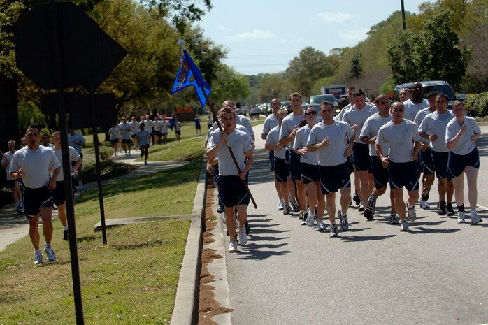 The 437th Communications Squadron finishes, as the first full formation during the 5k Commander's Fitness Challenge on Charleston AFB April 3. Airmen were highly encouraged to finish the 5K in formation but were allowed to run at their own pace at the half-way point. (U.S. Air Force photo/Senior Airman Timothy Taylor)