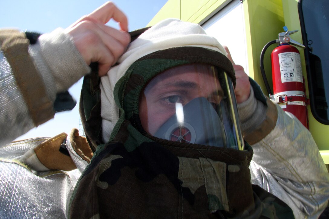 GRISSOM AIR RESERVE BASE, Ind., -- Master Sgt. Gary Smith, a fire protection journeyman with the 434th Civil Engineer Squadron, puts on his j-list fire protection ensemble during a recent exercise. Wearing the suit allows them to battle fires in a chemical environment. (U.S. Air Force photo/Staff Sgt. Mark Orders-Woempner)