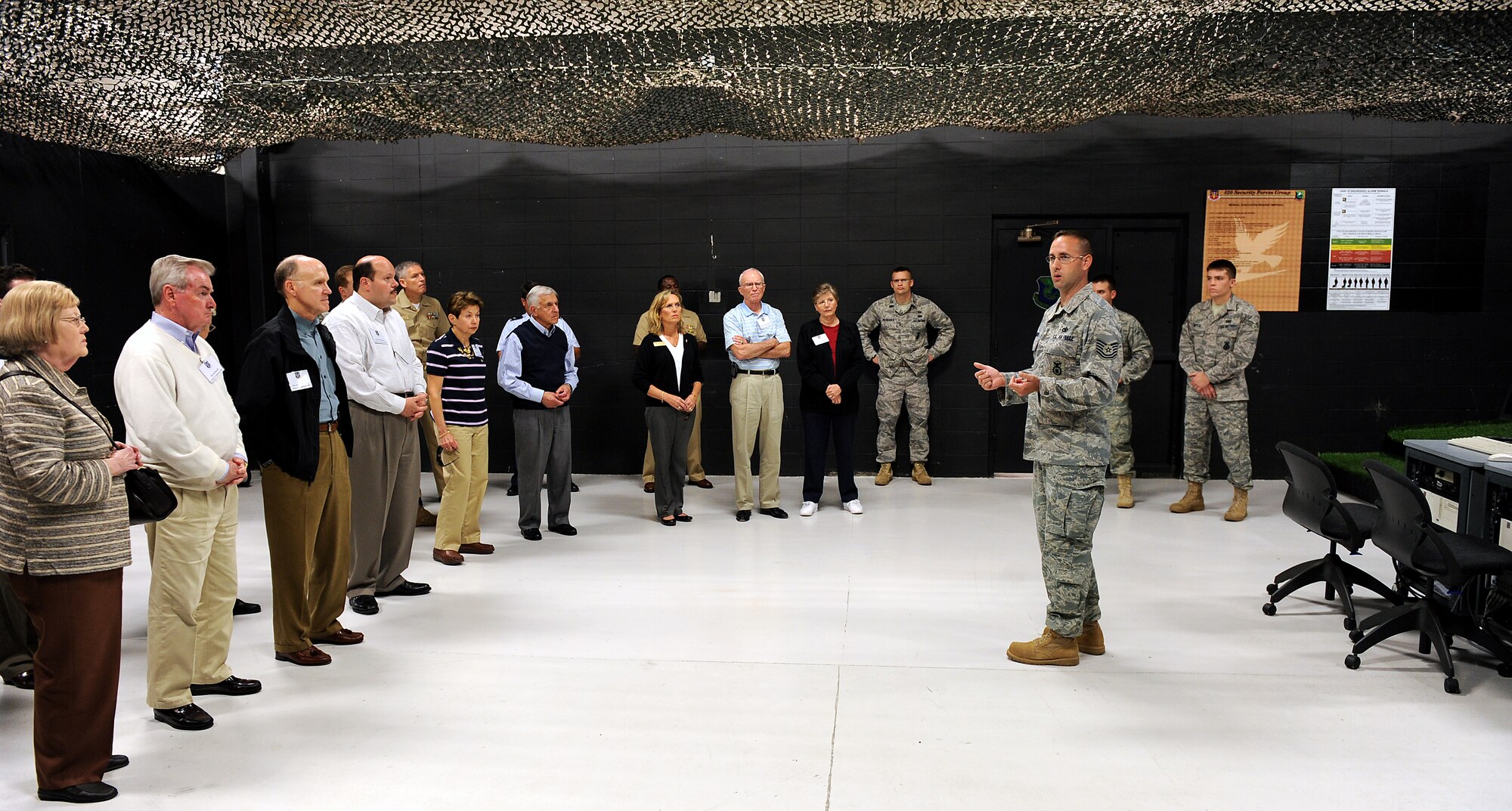 MOODY AIR FORCE BASE, Ga. -- Tech. Sgt. Scott Larson, 820th Security Forces Group combat technology NCO in-charge, briefs members of the Georgia Military Affairs Coordinating Committee during a base tour here April 6. Sergeant Larson explained how a shooting simulator operates. (U.S. Air Force photo by Airman Joshua Green) 