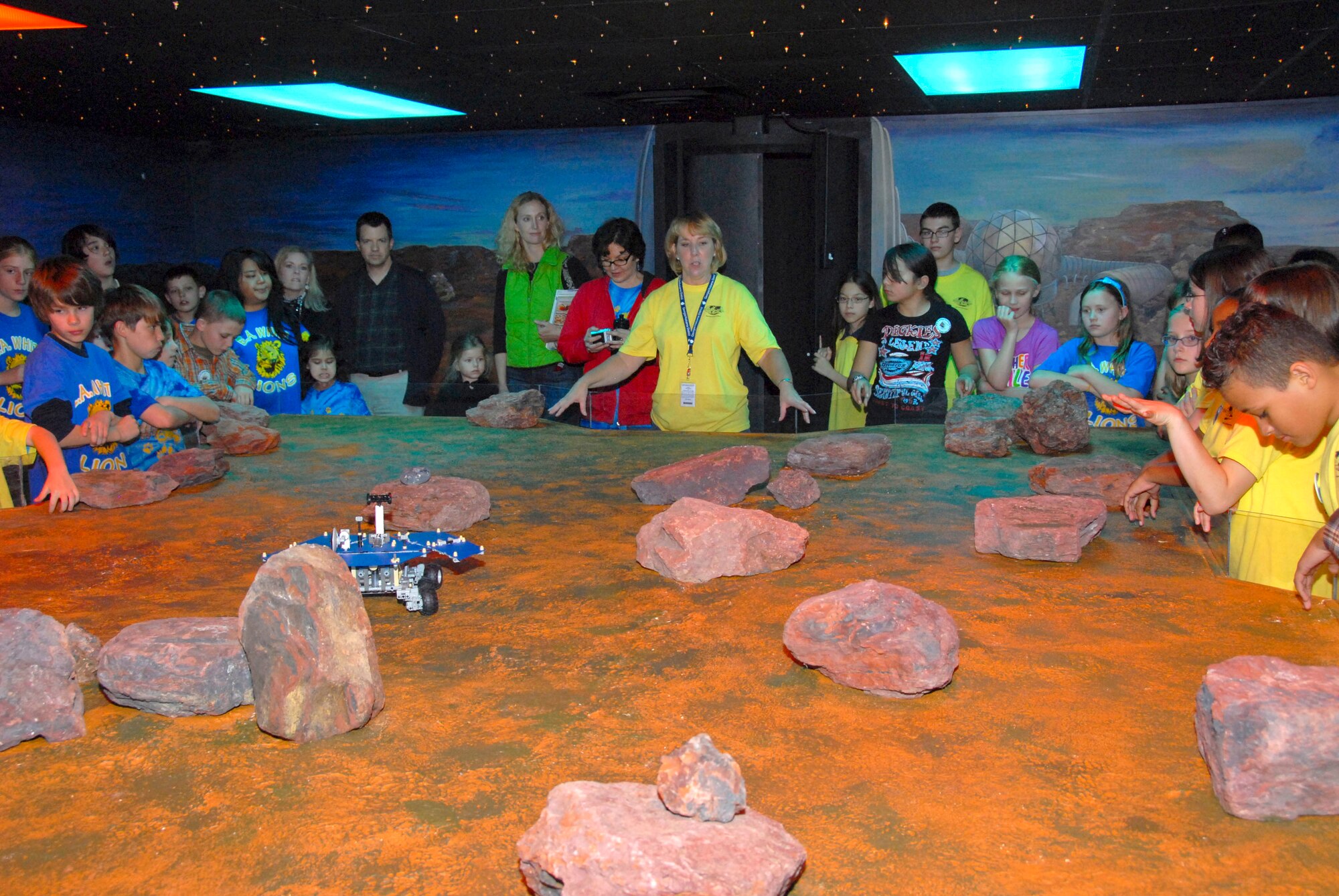 As a part of their tour for the First Lego League, students visited a replica of the Martian surface, led by teacher Becky Hill, at Starbase. Maxwell Elementary School hosted six regional schools for the FLL gathering, including six from Fort Benning, Ga. and one from Fort Rucker, Ala., on March 31. (Air Force photo by Jamie Pitcher)