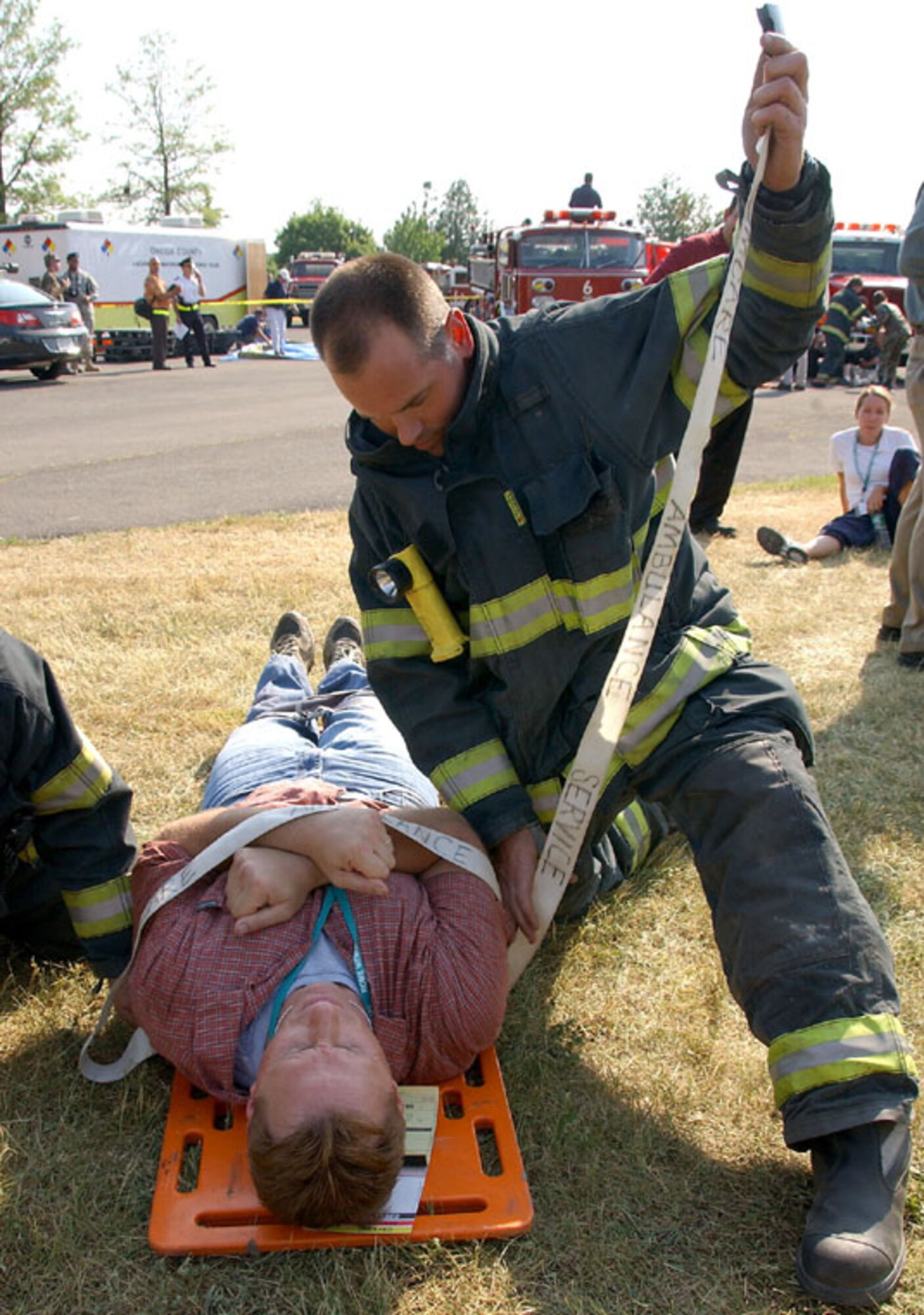 A Rome Fire Department firefighter works to stabilize a Northeast Air Defense Sector simulated victim during the Griffiss Park Mass Casualty Exercise Thursday. The exercise challenged first responders to perform their triage and hazmat procedures on victims of a simulated terrorist attack. Photo by Senior Airman Ricky Best 
