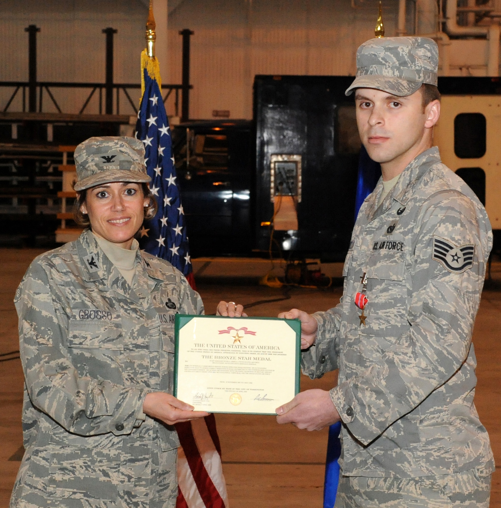 Staff Sgt. Peter Arbelo, 87th Civil Engineer Squadron Explosive Ordnance Disposal Flight, receives the Bronze Star from Col. Gina Grosso, 87th Air Base Wing commander, April 6. Sergeant Arbelo was awarded the medal for his service as the EOD team leader with the 447th Explosive Ordnance Disposal Bravo Flight in Baghdad, Iraq. From Nov. 20, 2007 to May 5, 2008, Sergeant Arbelo and his team executed more than 51 combat missions, which are critical to the excecution of counter insurgent operations. (U.S. Air Force photo/Wayne Russell)