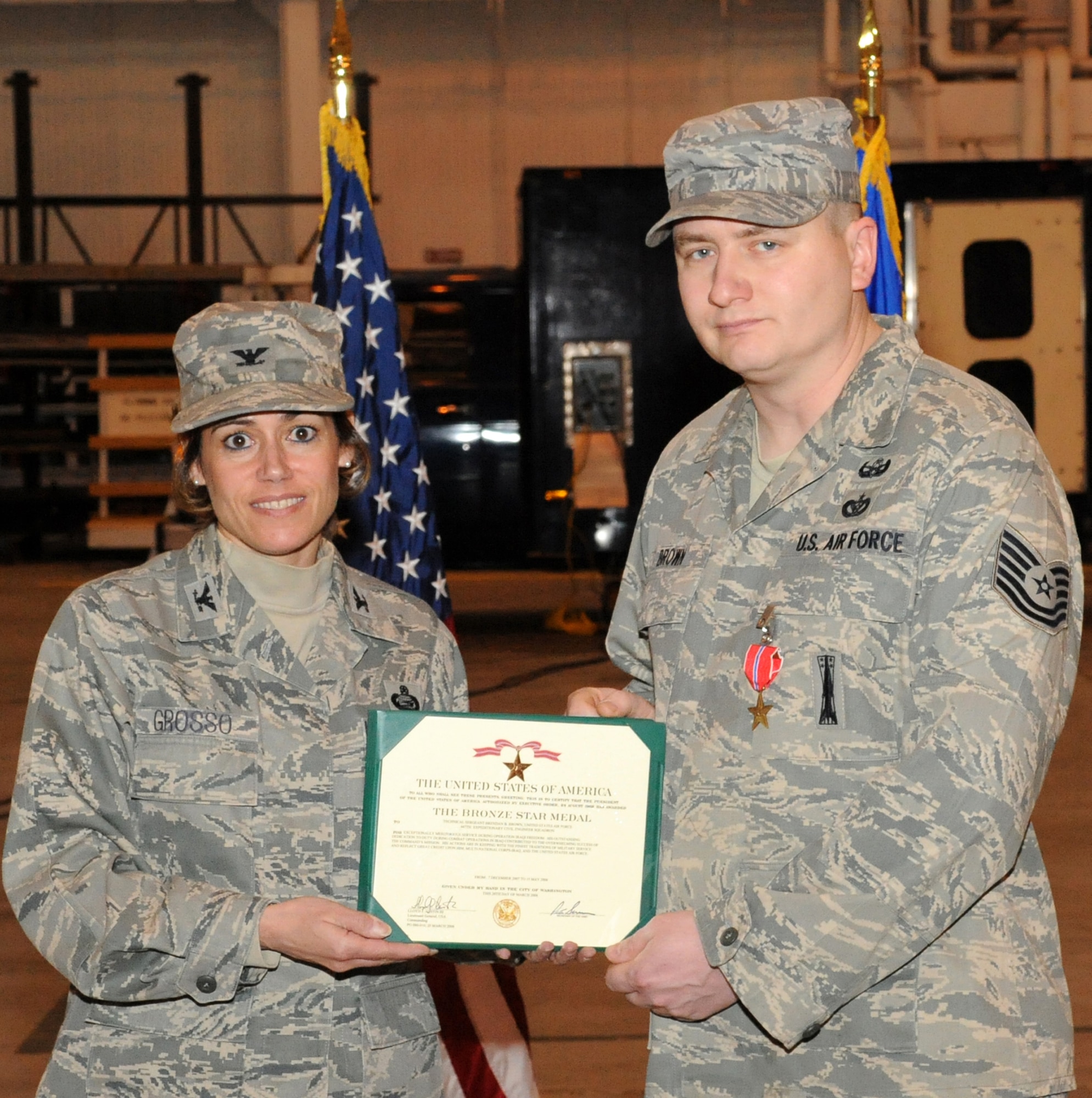 Technical Sgt. Brendan Brown, 87th Civil Engineer Squadron Explosive Ordnance Disposal Flight, receives the Bronze Star from Col. Gina Grosso, 87th Air Base Wing commander, April 6. Sergeant Brown was awarded the medal for his service as the EOD team leader with the 447th Explosive Ordnance Disposal Alpha Flight in Baghdad, Iraq. From Dec. 7, 2007 to May 15, 2008, his team responded to 43 emergency situations, and destroyed more than 700 pounds of explosives, 900 improvised explosive device components, and 3,050 ordnance items. (U.S. Air Force photo/Wayne Russell)