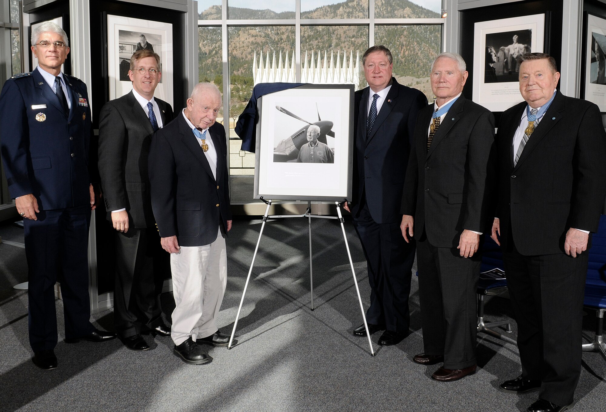 Lt. Gen. John F. Regni (left to right), David J. McIntyre, retired Col. Bernard Fisher, Secretary of the Air Force Michael B. Donley,  retired Cols. Leo Thorsness and Joe Jackson stand next to an unveiled a portrait of Colonel Fisher during the "Visions of Valor" dedication April 3 at the U.S. Air Force Academy in Colorado. General Regni is the Academy superintendent, Mr. McIntyre is the TriWest CEO, and Colonel Fisher is the first Air Force recipient of the Medal of Honor during the Vietnam War. Colonels Thorsness and Jackson are also Medal of Honor recipients for actions during the Vietnam War. (U.S. Air Force photo/Mike Kaplan)
