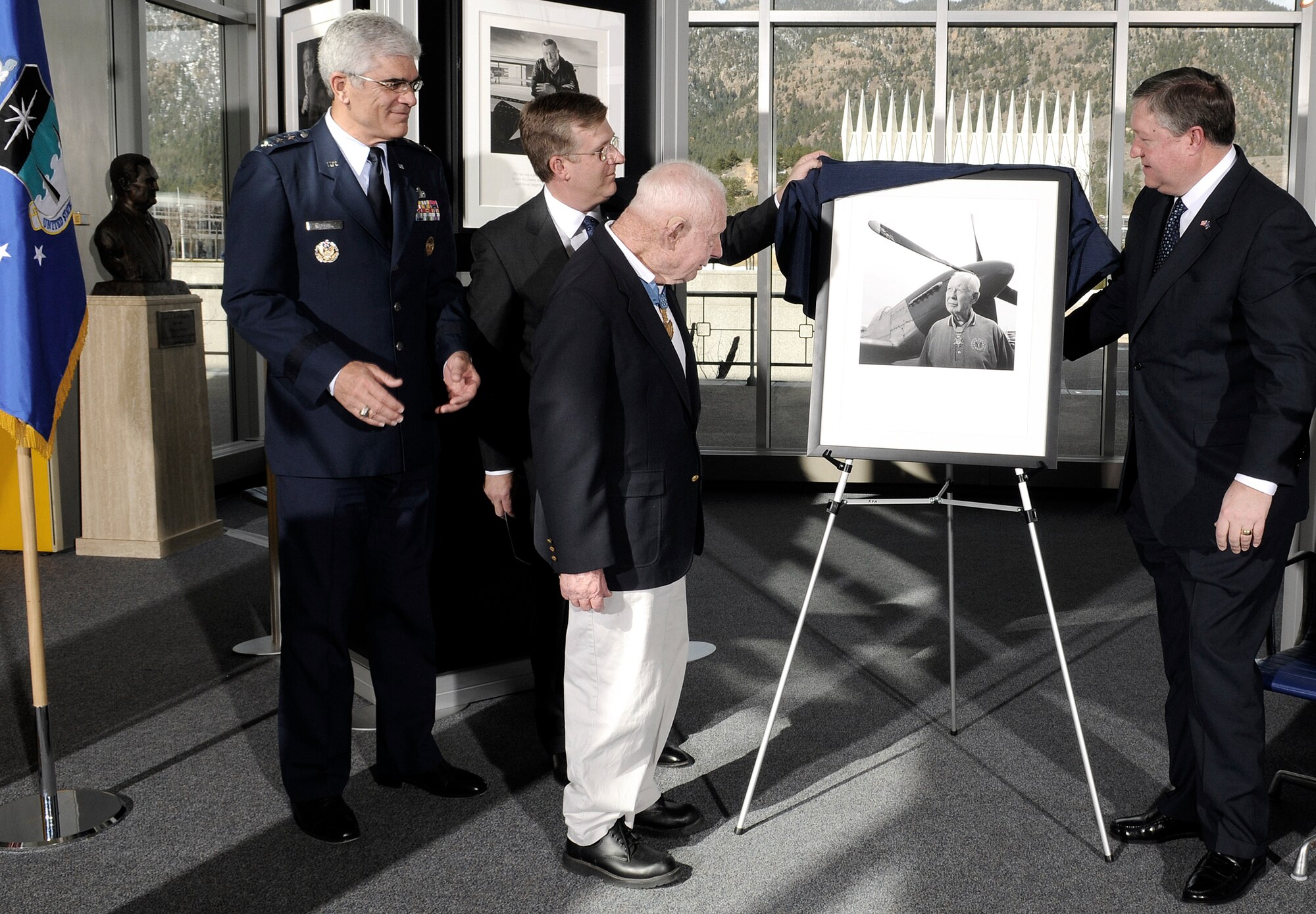Secretary of the Air Force Michael B. Donley unveils a portrait of retired Col. Bernard Fisher during the "Visions of Valor" dedication April 3 at the U.S. Air Force Academy in Colorado. Participating is Academy Superintendent Lt. Gen. John F. Regni and David J. McIntyre, the TriWest CEO. Colonel Fisher  is the first air commando and Air Force person to receive the Medal of Honor in Vietnam. (U.S. Air Force photo/Mike Kaplan)
