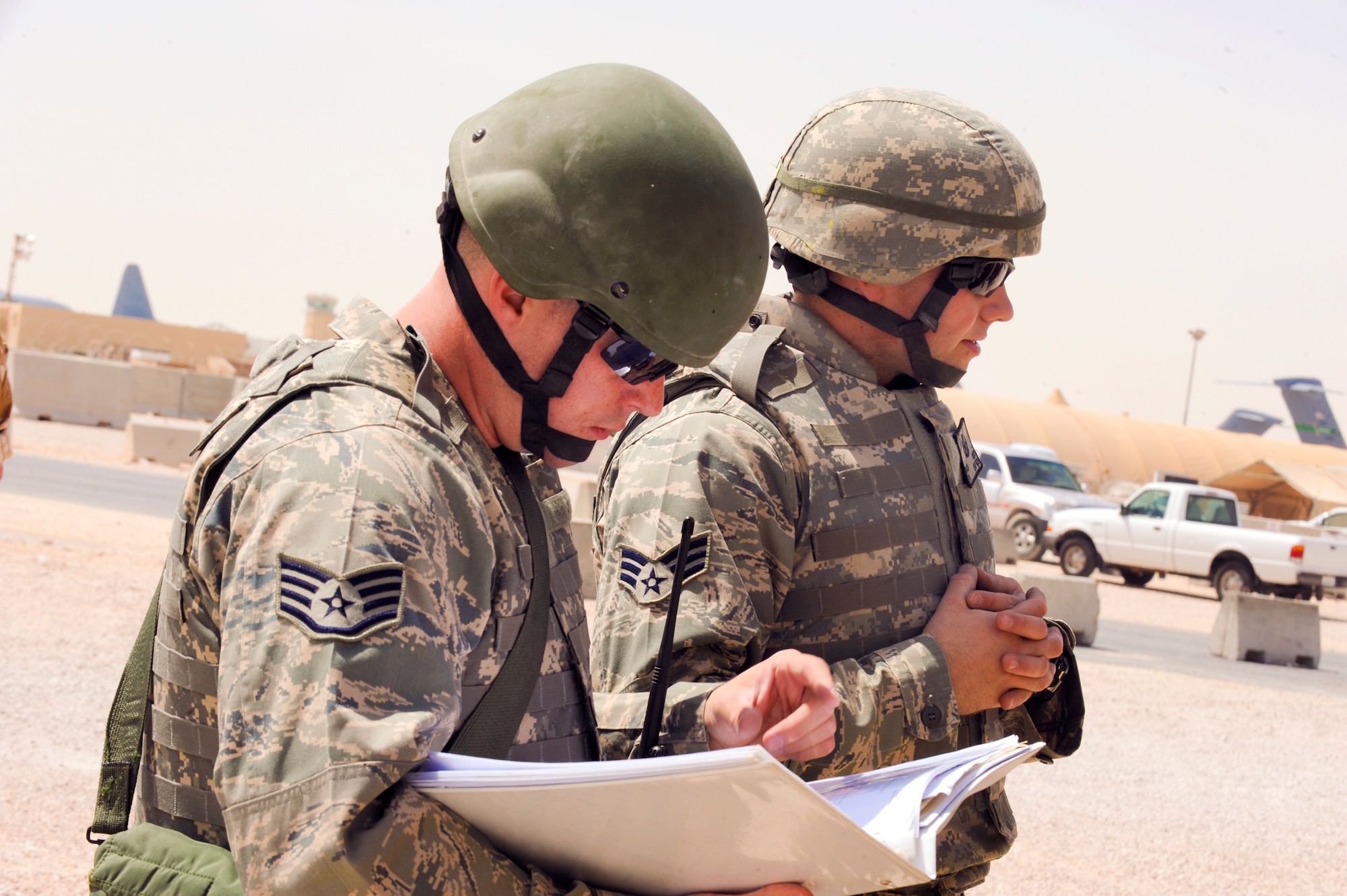 Staff Sgt. Macord Johnson and Senior Airman Brok Flint, both Explosive Ordnance Disposal Technicians with the 379th Expeditionary Civil Engineer Squadron, hold a safety brief prior to entering an area with an unidentified exploded object during a base exercise, April 8, 2009, in an undisclosed location in Southwest Asia.  Sergeant Johnson hails from Spokane, Wash. and is deployed from Nellis Air Force Base, Nev.  Airman Flint is native to Lancaster, Ohio and is deployed from Spangdahlem Air Base, Germany, both are deployed in support of Operations Iraqi and Enduring Freedom and Combined Joint Task Force - Horn of Africa.  (U.S. Air Force Photo by Staff Sgt. Joshua Garcia/released)