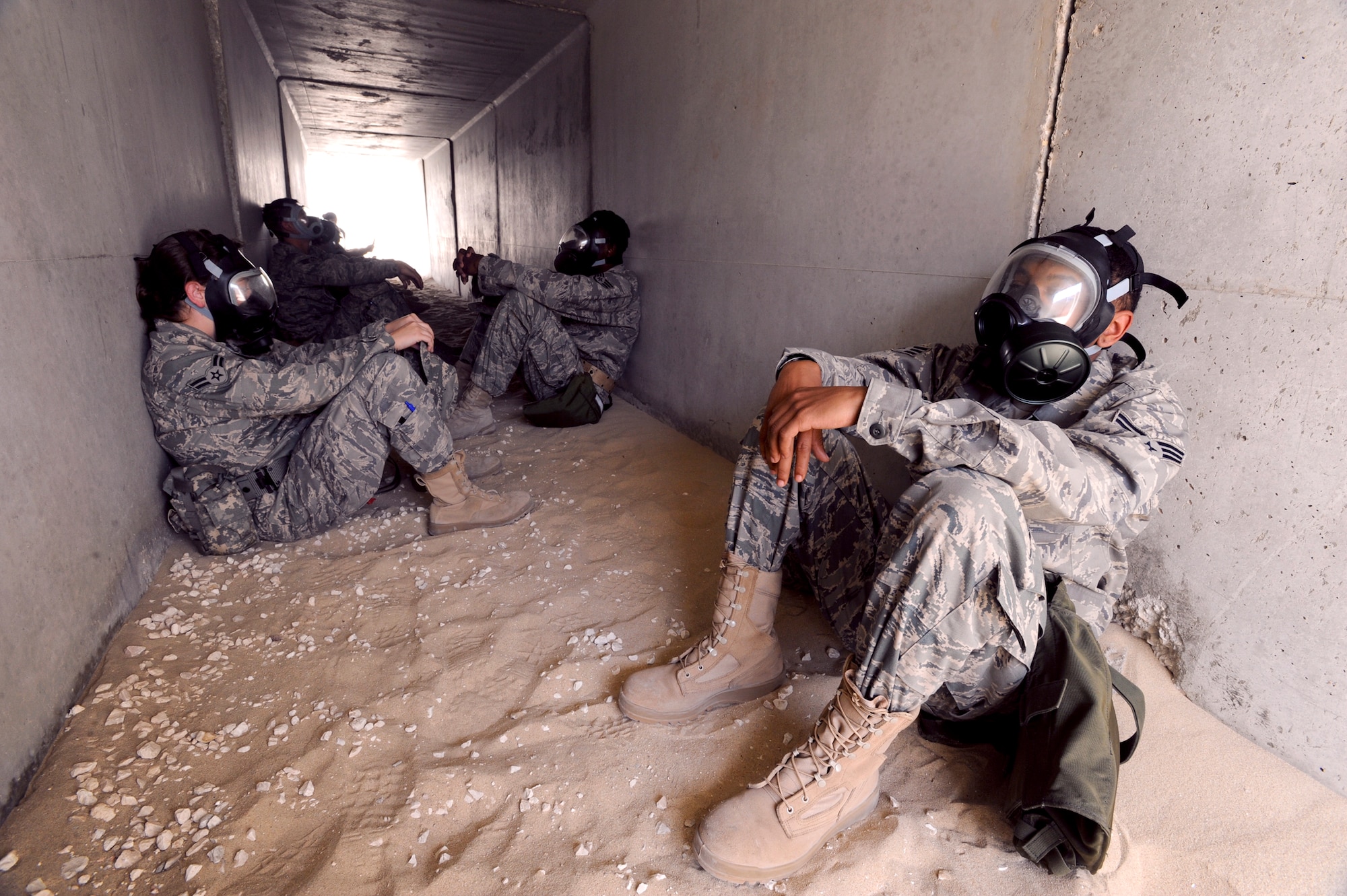 Senior Airman Jay Brown, 379th Expeditionary Operations Squadron, has taken cover alongside fellow 379th Air Expeditionary Wing members in a bunker during a base exercise, April 8, 2009, in an undisclosed location in Southwest Asia.  The exercise tested unit readiness and ability to operate during an attack on the base.  Airman Brown is native to Fayetteville, N.C. and is deployed from Seymour Johnson Air Force Base, N.C. in support of Operations Iraqi and Enduring Freedom and Combined Joint Task Force - Horn of Africa.  (U.S. Air Force Photo by Staff Sgt. Joshua Garcia/released)