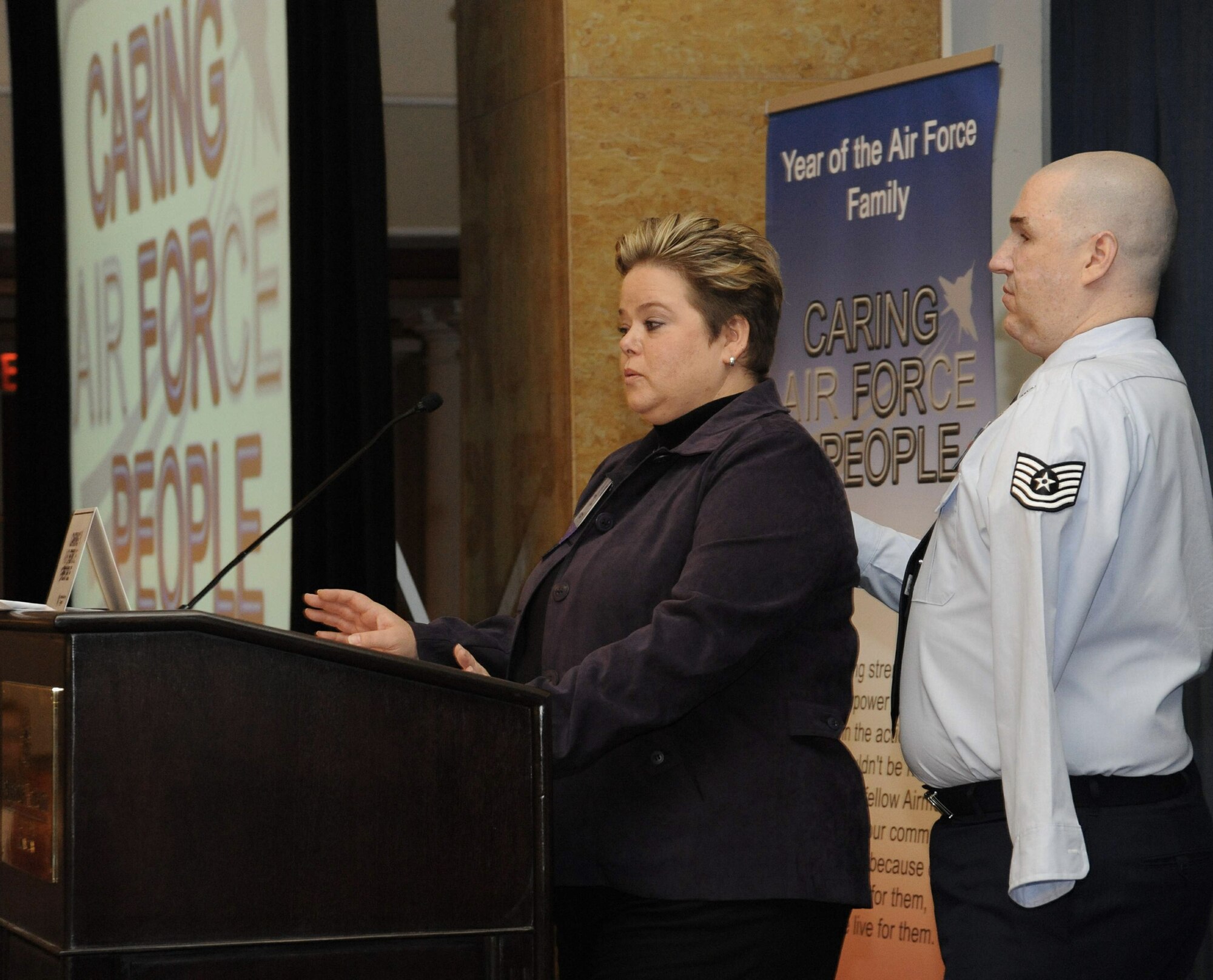 Annette Slaydon and her husband, Tech. Sgt. Matt Slaydon, speak to the audience and senior leadership panel during the Year of the Air Force Family: Caring for People Forum April 2 in Arlington, Va. The Slaydons spoke about the importance of deployment preparation, wounded warrior care and the importance of the Air Force family. Sergeant Slaydon is an explosive ordnance technician from Luke Air Force Base, Ariz., who received extensive injuries from a terrorist's improvised explosive device in 2007 while deployed to northern Iraq. Sergeant Slaydon lost vision in both eyes and his left arm. (U.S. Air Force photo/Staff Sgt. Patrick Brown) 
