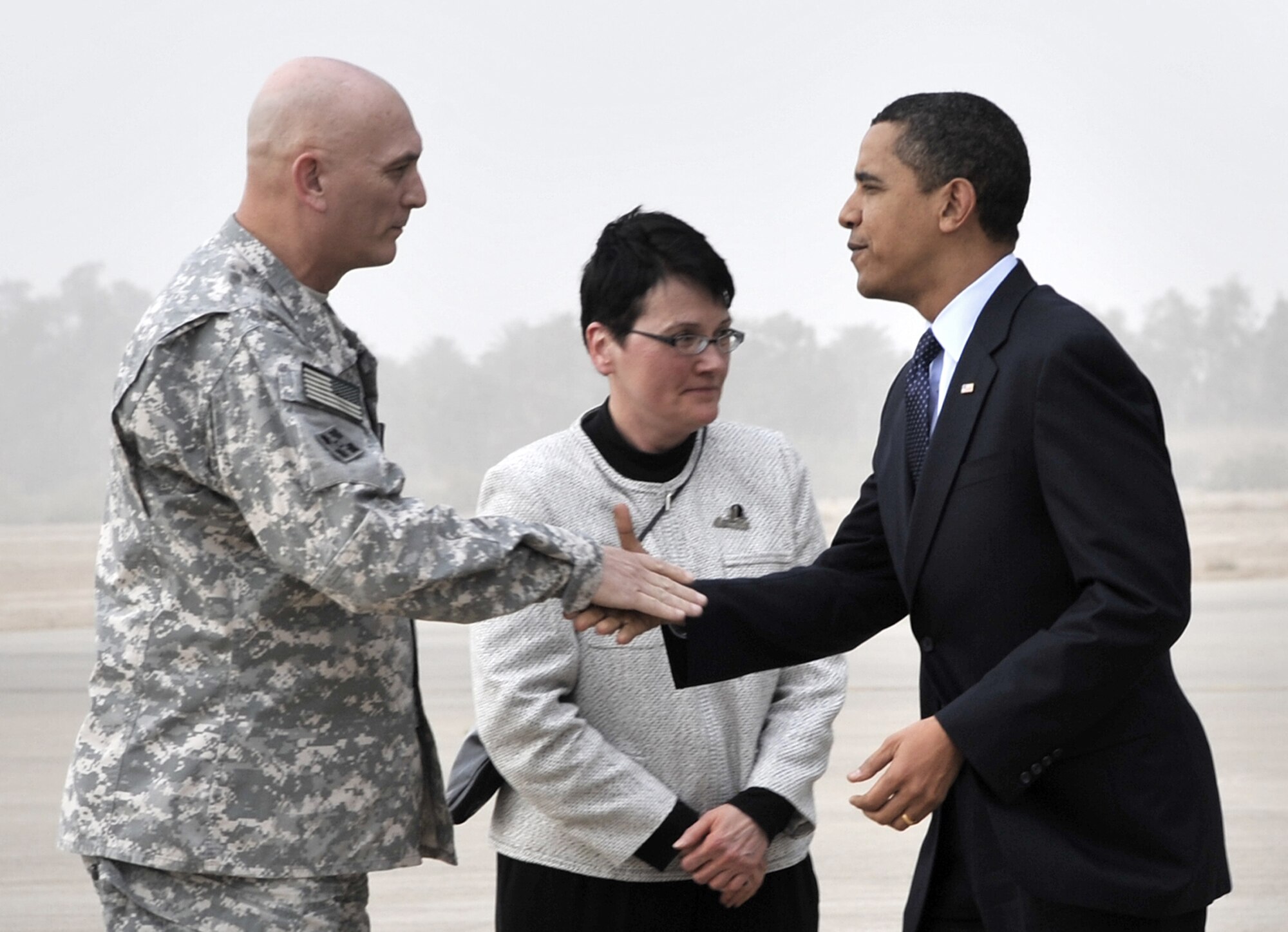 Army Gen. Ray Odierno and U.S. Ambassador Patricia Butenis greet President Barack Obama on the flightline April 7 at Sather Air Base, Iraq. Shortly after arriving, the president addressed a crowd of nearly 1,500 servicemembers, government civilians and contractors at Al Faw Palace at Camp Victory, Iraq. During his speech, the president commended servicemembers for their focus and dedication and promised them his support. The visit marked the president's first trip to Iraq since taking office. General Odierno is the Multinational Forces-Iraq commanding general. (U.S. Air Force photo/Staff Sgt. Amanda Currier) 

