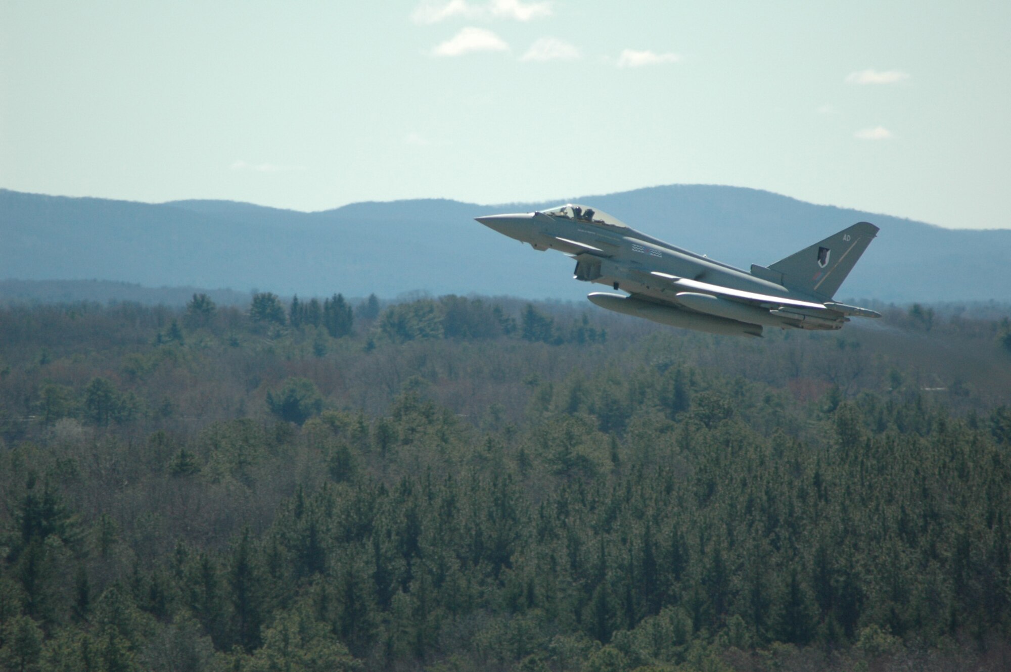 A Royal Air Force F2 Typhoon fighter climbs out of Westover March 31. The British aircraft was among three RAF jets that visited Westover for an overnight stay before departure to California. Westover's transient alert service, long runways, and proximity to Europe are among the reasons why foreign aircraft and those of the other American armed services frequently transit the base. Westover's transient alert staff welcomed more than 420 transient and foreign military and civilian aircraft in 2008. (photo by Tech. Sgt. Andrew Biscoe) 