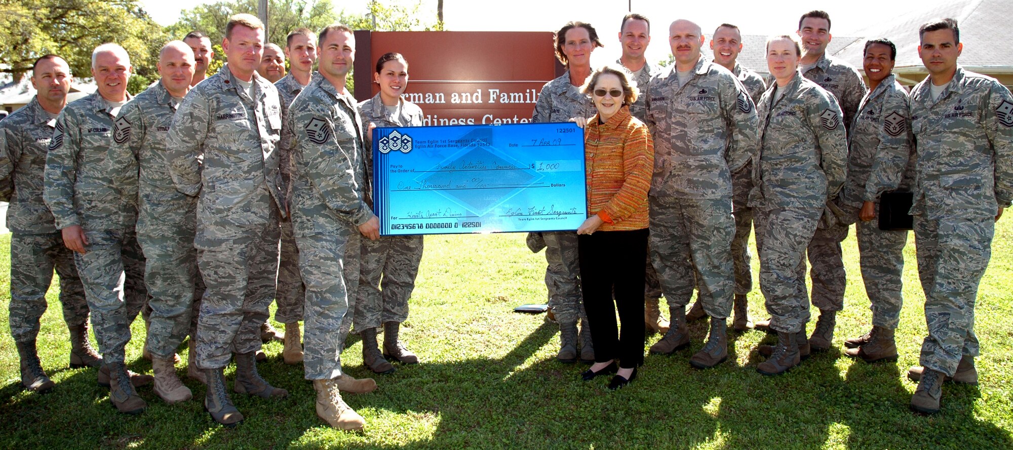 EGLIN AIR FORCE BASE, Fla. -- The First Sergeants Council presented the Airman and Family Readiness Center a check for $1,000 April 7, to fund their Hearts Apart Dining program. (U.S. Air Force photo/ Airman Anthony Jennings)