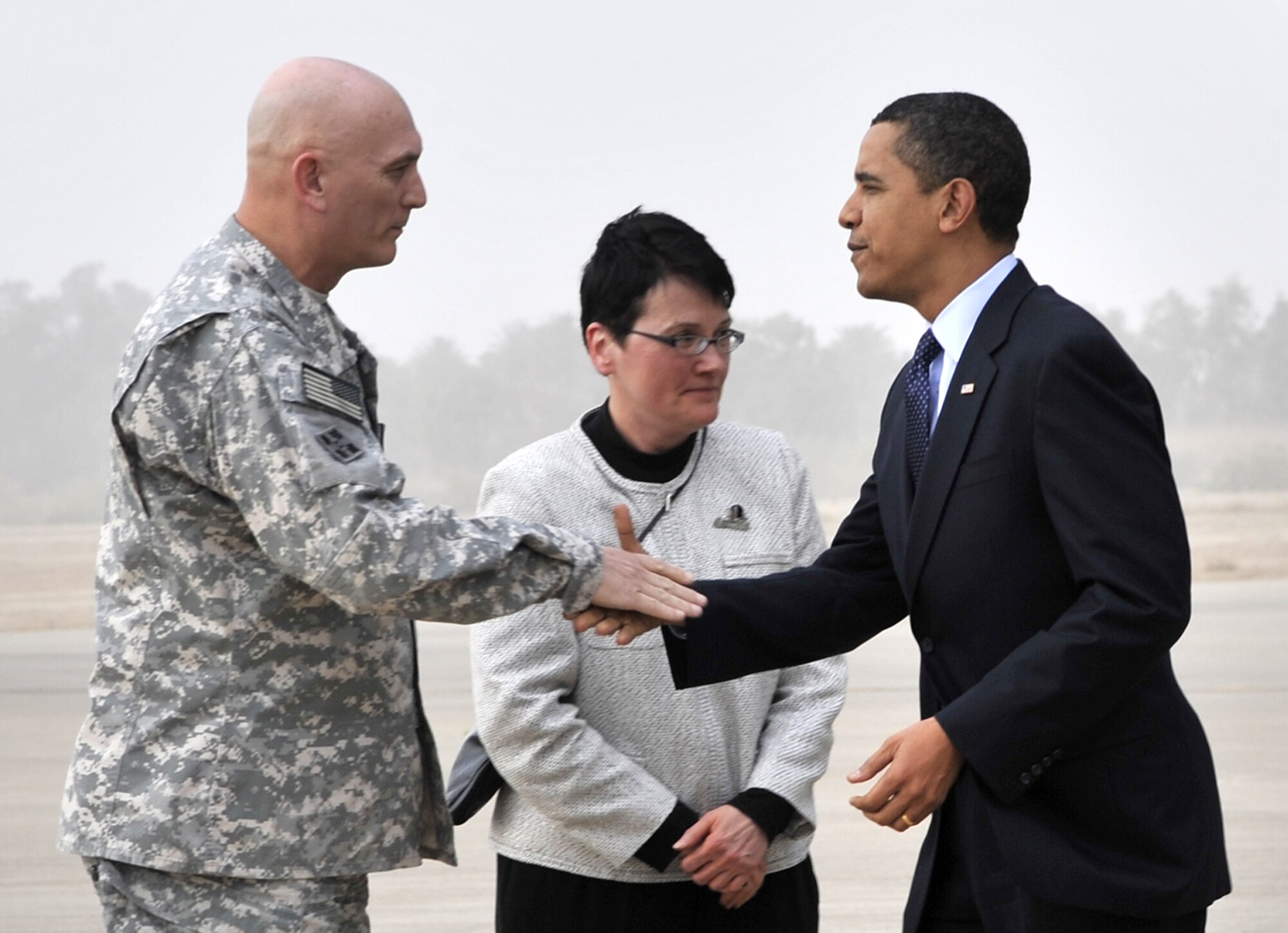 SATHER AIR BASE, Iraq, - Gen. Ray Odierno, commanding general Multi-National Forces Iraq, and U.S. Ambassador Patricia Butenis, greet President Barack Obama on the flightline here April 7. Shortly after arriving, the president addressed a crowd of nearly 1,500, servicemembers, government civilians and contractors, at Al Faw Palace, Camp Victory, Iraq. During his speech, the president commended servicemembers for their focus and dedication and promised them his support. The visit marked the president’s first trip to Iraq since taking office. (U.S. Air Force Photo by Staff Sgt. Amanda Currier)