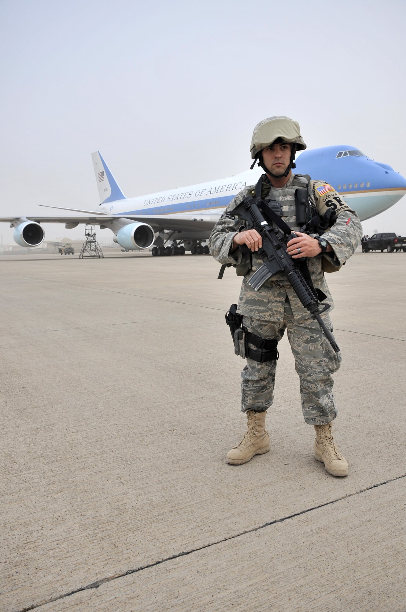 SATHER AIR BASE, Iraq, - Staff Sgt. Matthew Smith, a 447th Expeditionary Security Forces Squadron member, guards Air Force One April 7 on the flightline here. Members of the 447th ESFS protected Air Force One while President Barack Obama spoke to a crowd of nearly 1,500, servicemembers, government civilians and contractors, at Al Faw Palace, Camp Victory, Iraq, during an unannounced visit to Iraq. The visit marked the president’s first trip to Iraq since taking office. (U.S. Air Force Photo by Staff Sgt. Amanda Currier)