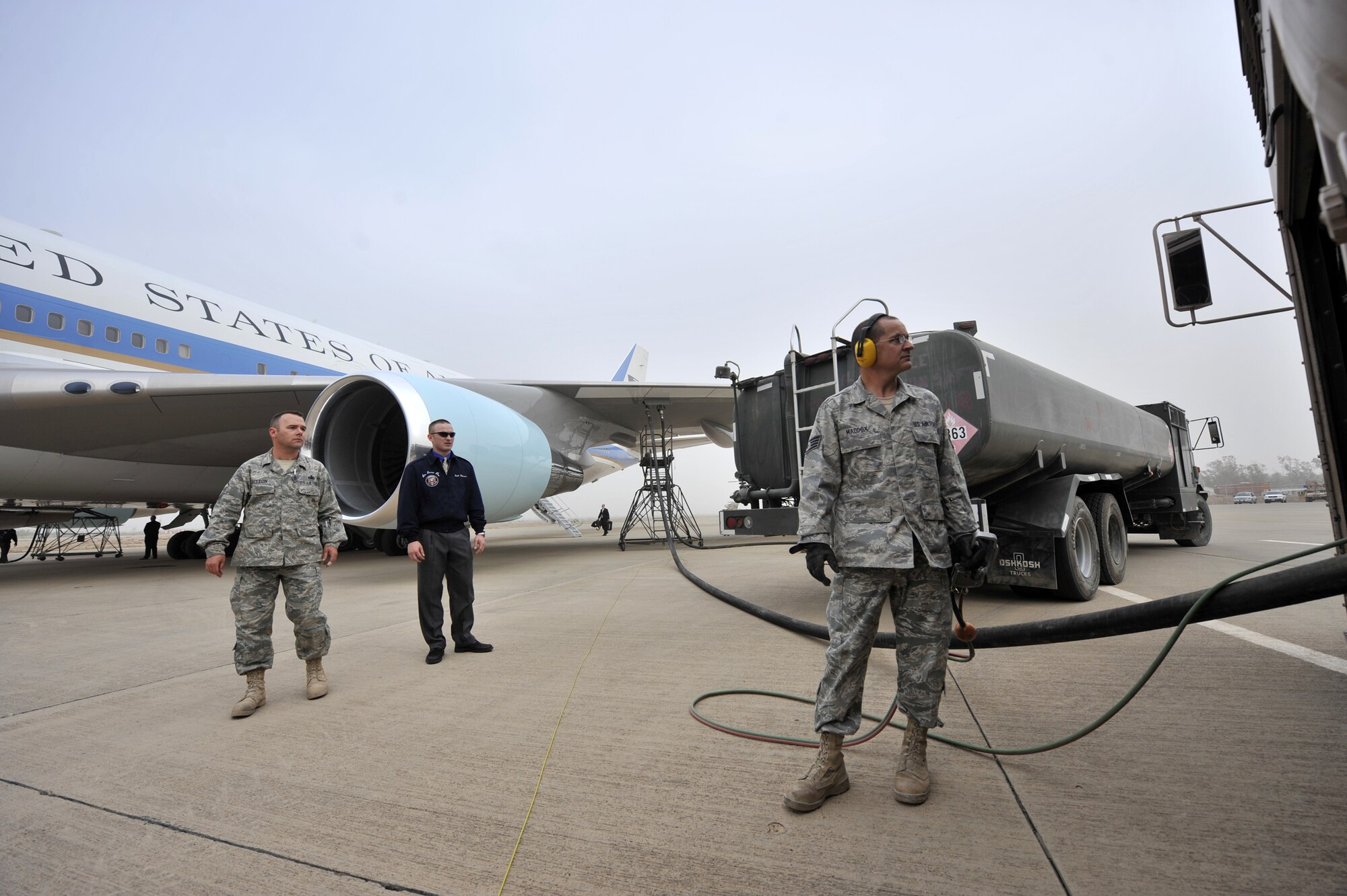 SATHER AIR BASE, Iraq, - Staff Sgt. Donald Maddox, a 447th Expeditionary Logistics Readiness Squadron fuel distribution technician, refuels Air Force One April 7 on the flightline here while Master Sgt. Joel Sutton, 447th ELRS fuels manager, and an Air Force One crew chief stand ready to assist. Members of the 447th ELRS refueled Air Force One after President Barack Obama landed here for an unannounced visit to servicemembers in Iraq. (U.S. Air Force Photo by Staff Sgt. Amanda Currier)