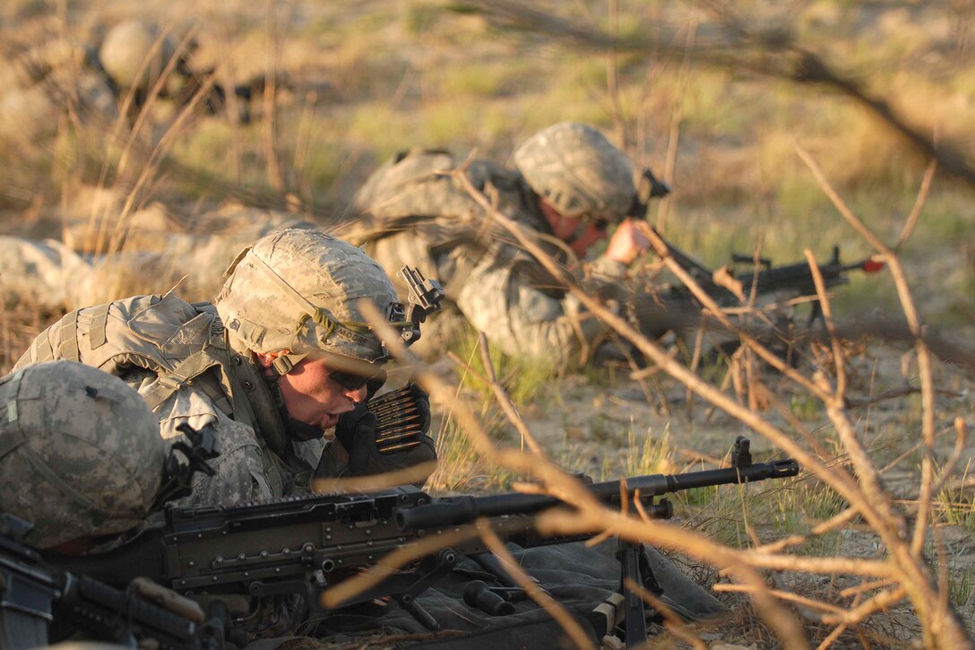 U.S. Army Spc. Jason Moore, center, stays "fired up" during an air-assault, live-fire exercise on training ranges during early evening on Fort Bragg, N.C., April 3, 2009. Moore is assigned to the 82nd Airborne Division's Company C, 2nd Battalion, 504th Parachute Infantry Regiment, 1st Brigade Combat Team.