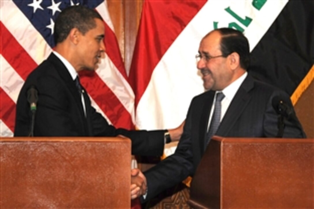 U.S. President Barack Obama shakes hands with Prime Minister Nouri al-Maliki after a joint press event on Camp Victory, Iraq, April 7, 2009. Obama spoke to hundreds of U.S. troops during his surprise visit to Iraq to thank them for their service.