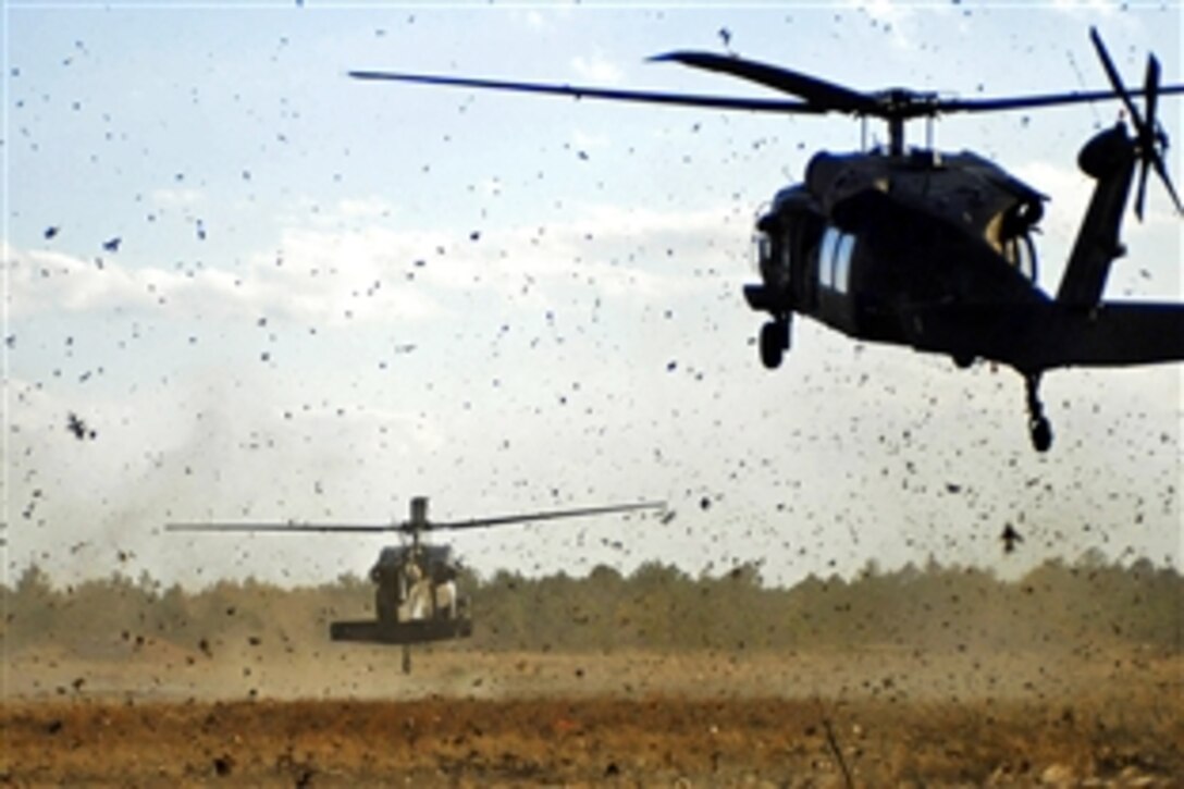 Two UH-60 Black Hawk helicopters land on training ranges to drop off U.S. Army soldiers during an air-assault, live-fire training exercise on Fort Brag, N.C., April 3, 2009. The soldiers are assigned to the 82nd Airborne Division's Company C, 2nd Battalion, 504th Parachute Infantry Regiment, 1st Brigade Combat Team. 
