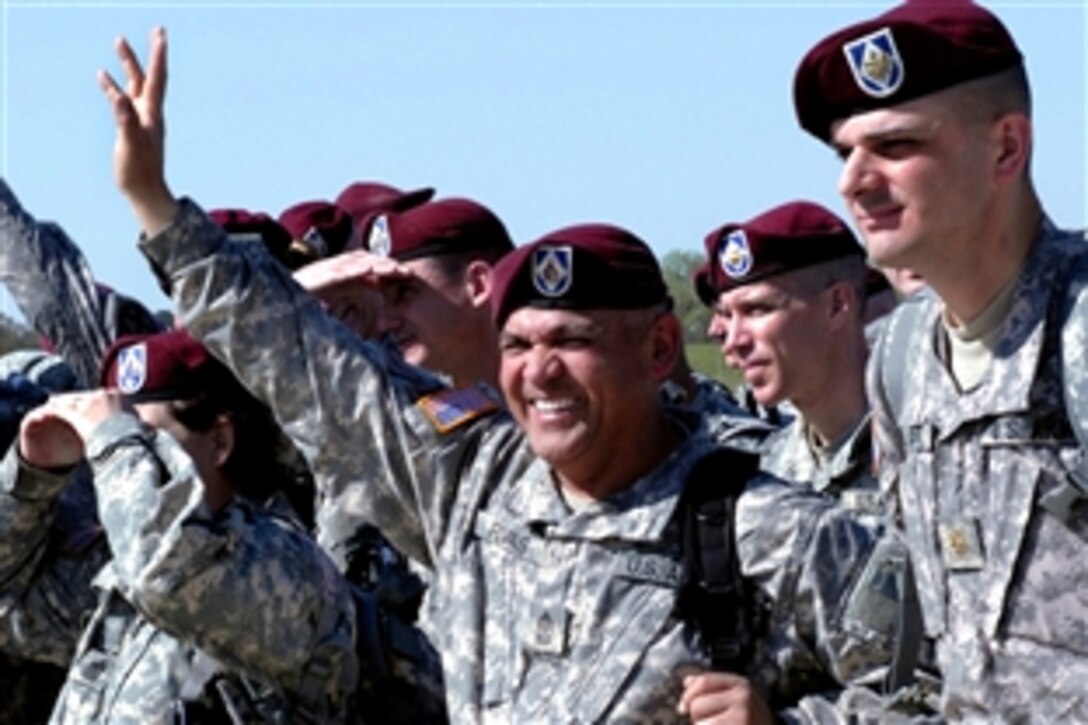 U.S. Army Sgt. Maj. William Rivas waves to loved ones from the flightline on Pope Air Force Base, April 4, 2009, after returning from 15 months in support of Operation Iraqi Freedom. The deployment was the longest in the unit's history. Rivas is assigned to the 18th Airborne Corps' Company A.