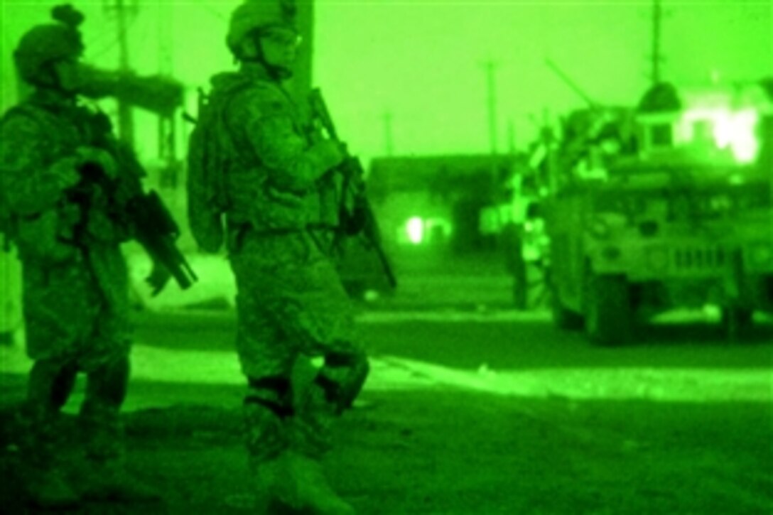 As seen through a night vision device, U.S. Army soldiers provide security at the scene of recent fighting in Al-Fadhel in eastern Baghdad, Iraq, March 28, 2009. The soldiers are assigned to the 82nd Airborne Division's 3rd Brigade Combat Team.