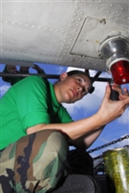 U.S. Navy Airman Ashley Westcott does preventive maintenance to an anti-collision light on a MH-60S Sea Hawk helicopter on the flight deck of the aircraft carrier USS John C. Stennis (CVN 74) in the Pacific Ocean on April 4, 2009.  The aircraft is from Helicopter Sea Combat Squadron 8.  The Stennis and Carrier Air Wing 9 are on a six-month deployment to the western Pacific Ocean.  