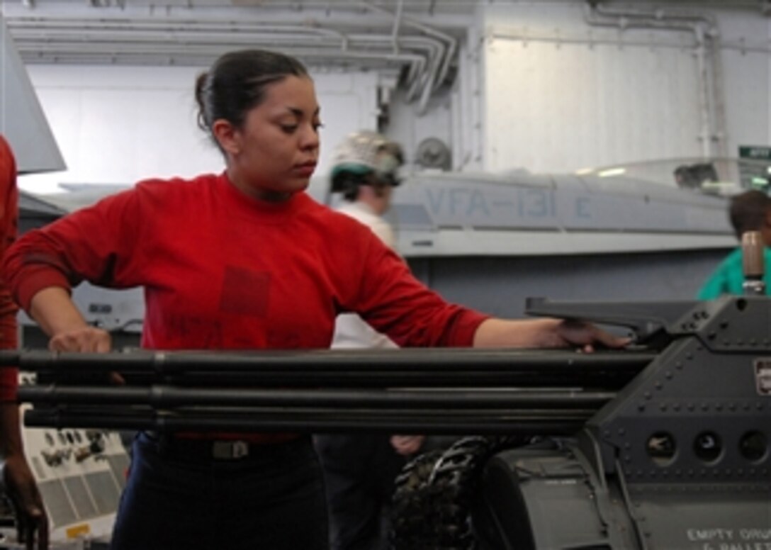 U.S. Navy Airman Luisa Villanueva aligns the barrels on an M-61A2, 20 mm gun in the hangar bay aboard the aircraft carrier USS Dwight D. Eisenhower (CVN 69) in the Arabian Sea on April 7, 2009.  The Eisenhower Carrier Strike Group is underway for a deployment in support of the ongoing rotation of forward-deployed forces.  