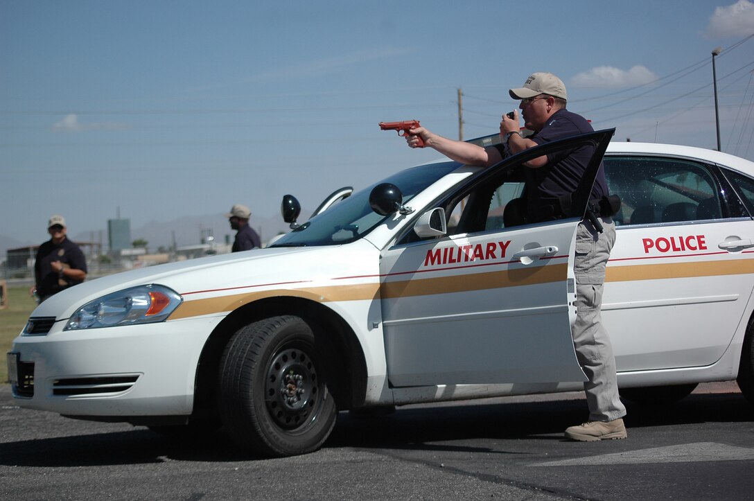 Kevin McGillvray, Marine Corps Air Station Yuma, Ariz., Marine Corps Police Academy cadet, orders a suspect to step out of his vehicle during a known-risk traffic stop exercise in a parking lot on station April 8, 2009. The exercise was part of McGillvray’s final law enforcement performance evaluation. McGillvray is one of the last 13 cadets to graduate from the station academy. Future cadets will be sent to the Marine Corps Air Station Miramar, Calif., academy, along with cadets from each West Coast installation.
