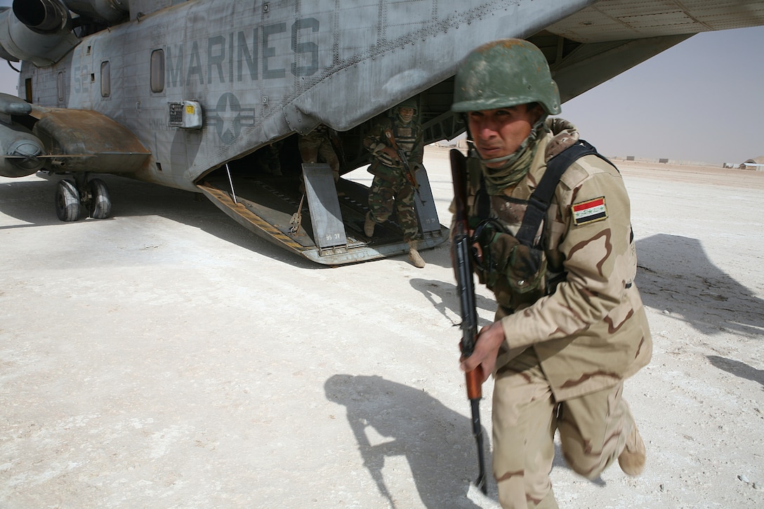 Iraqi Army commandos with the 7th Iraqi Army Division disembark a Super Stallion CH-53E helicopter at the Camp Ripper landing zone, Camp Ripper, Iraq, April 9. Reconnaissance Marines with 2nd Platoon, Company B, 1st Reconnaissance Battalion, Regimental Combat Team 8, have been instructing the commandos in basic infantry tactics during a month-long training package.