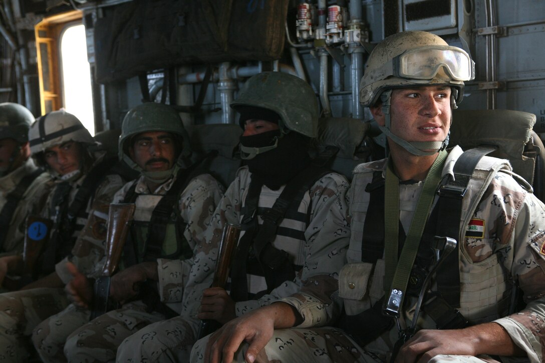 Iraqi Army commandos with the 7th Iraqi Army Division ride in a Super Stallion CH-53E helicopter toward the Camp Ripper landing zone, Camp Ripper, Iraq, April 9. Reconnaissance Marines with 2nd Platoon, Company B, 1st Reconnaissance Battalion, Regimental Combat Team 8, have been instructing the commandos in basic infantry tactics during a month-long training package.