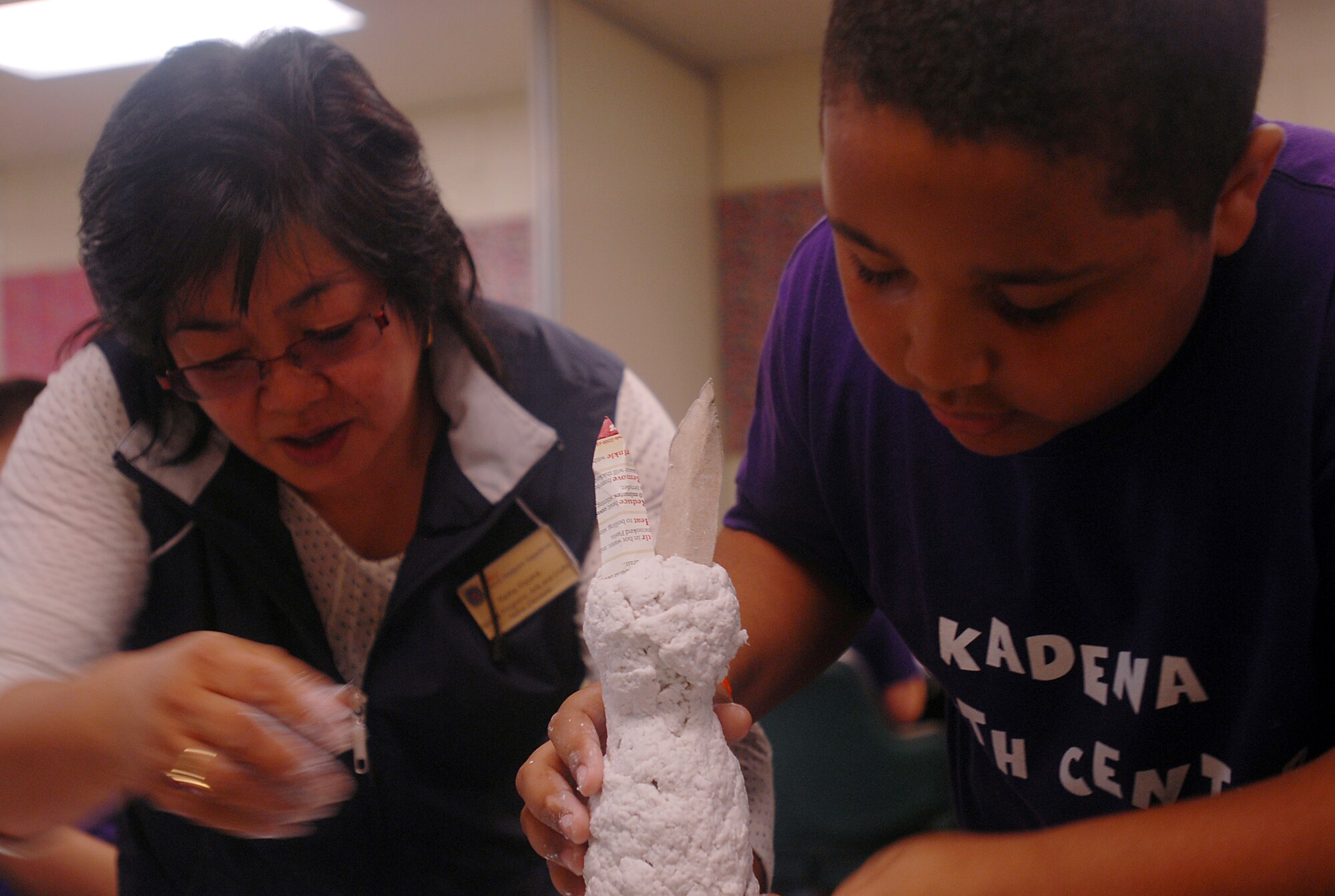 Ethan Stewart (right), son of Arthur and Cindy Stewart, 525th Electronic Maintenance Squadron, gets help with his paper mache Easter bunny from Reika Kiyuna, 18th Force Support Squadron's arts and crafts center. The Kadena Youth Center and School Age Program offer a variety of activities for youths during spring break.
(U.S. Air Force official photo/Staff Sgt. Nestor Cruz)