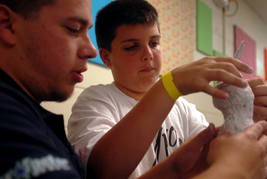 Jesse Smith (right), son of Jen and Tech. Sgt. Josh Smith, 31st Rescue Squadron, gets help with his paper mache Easter bunny from Victor Correa, 18th Force Support Squadron recreational assistant. The Kadena Youth Center and School Age Program offer a variety of activities for youths during spring break.
(U.S. Air Force official photo/Staff Sgt. Nestor Cruz)