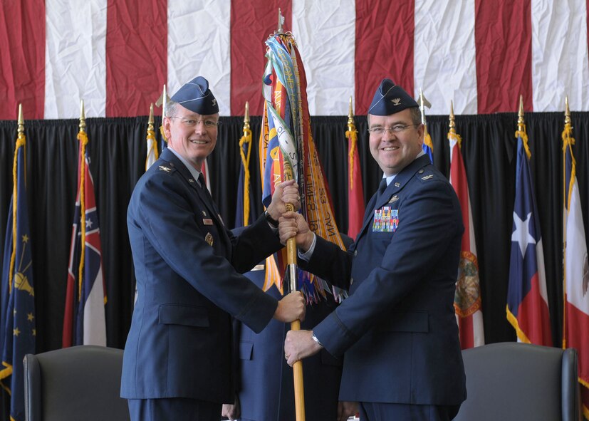 YOKOTA AIR BASE, Japan -- Col. Jeff Newell (left), 374th Airlift Wing commander, presents the 374th Operations Group guidon to Col. Mark Hering, the new 374th OG commander, during an assumption of command ceremony April 9. (U.S Air Force photo/Airman Devin Doskey) 