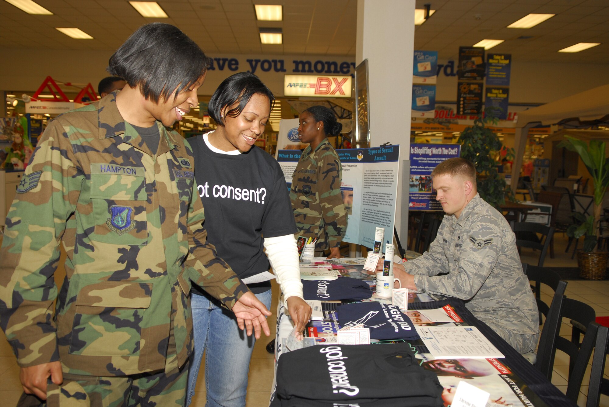 Staff Sgt. Ebony Hampton, (left), receives a sexual assault information brochure from Staff Sgt. Diannya Claiborn at the Base Exchange April 8, during the Sexual Assault Awareness month at Osan Air Base, Republic of Korea. The month of April is Sexual Assault Awareness Month and the theme for 2009 is “My Strength is for Defending.” Sergeant Hampton is assigned to the 51st Fighter Wing (U.S. Air Force Photo/Senior Airman Stephenie Wade)