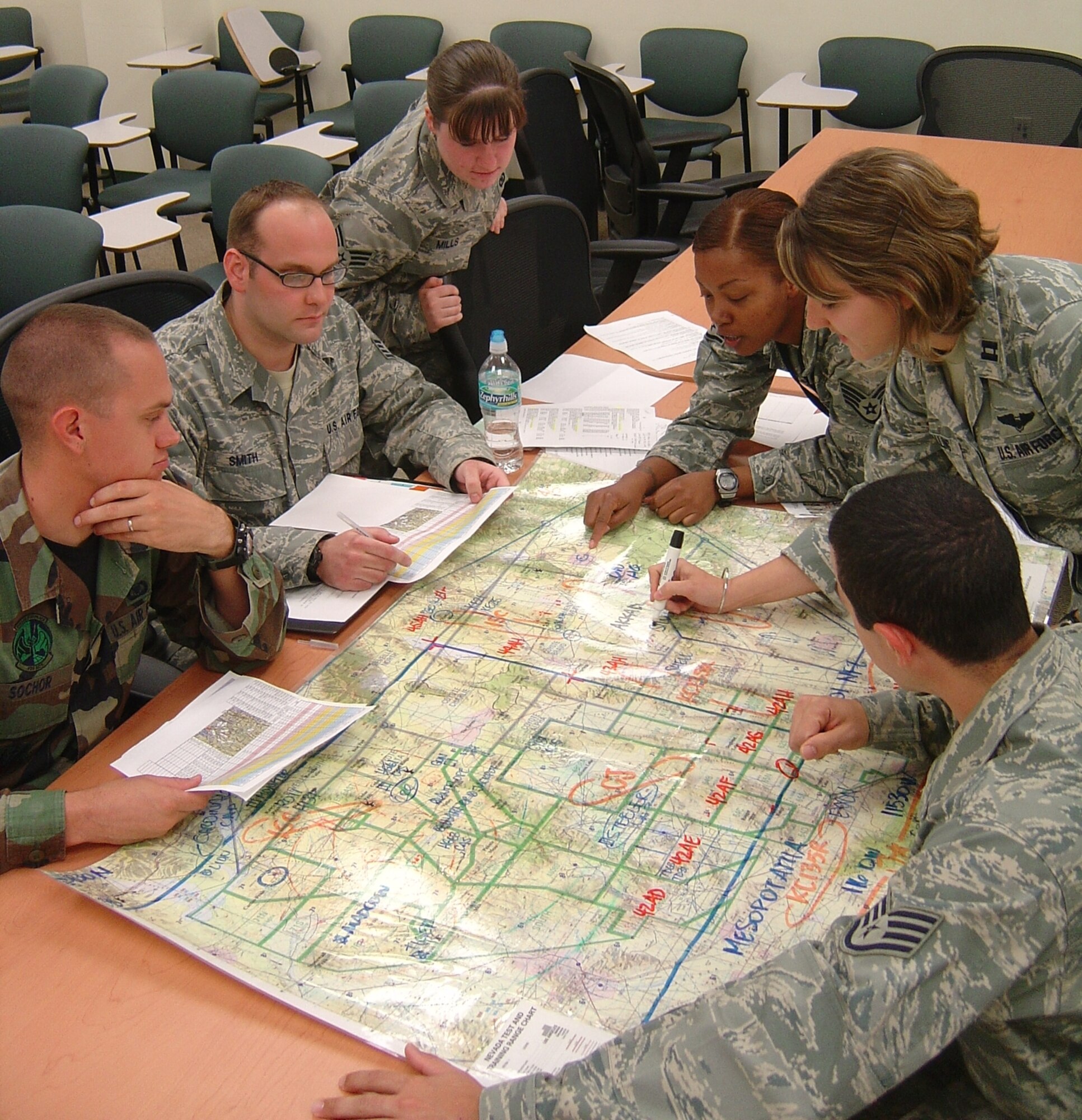 EGLIN AIR FORCE BASE, Fla. -- The 728th Air Control Squadron selected Turkey Shoot competition team review a map of the Nevada Test and Training Range, where the simulated war took place during a March exercise. From left to right are Airman 1st Class Robert Sochor, Staff Sgt. Andrew Smith, Senior Airman Lisa Mills, Staff Sgt. LaToya Johnson, Capt. Kisha Balling and Staff Sgt. Anthony Rigazio. (U.S. Air Force photo/Capt. Brian Mansfield)