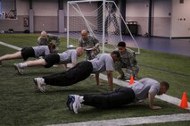 Soldiers from Fort Wainwright do push-ups for their physical fitness test April 9, 2009, Eielson Air Force Base, Alaska. Soldiers are a common sight at Eielson's fitness center, which has a large indoor track and field. The close proximity of the two military installations promotes good relations and provides many opportunites to interact. (U.S. Air Force photo/Airman 1st Class Laura Max)

